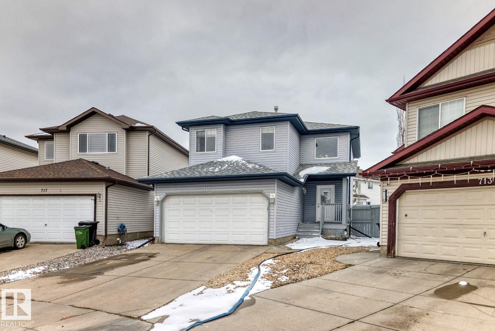 Two-story residence featuring light gray siding exterior and a light gray shingle roof - 715 Hudson Place, Edmonton, AB - Outdoor