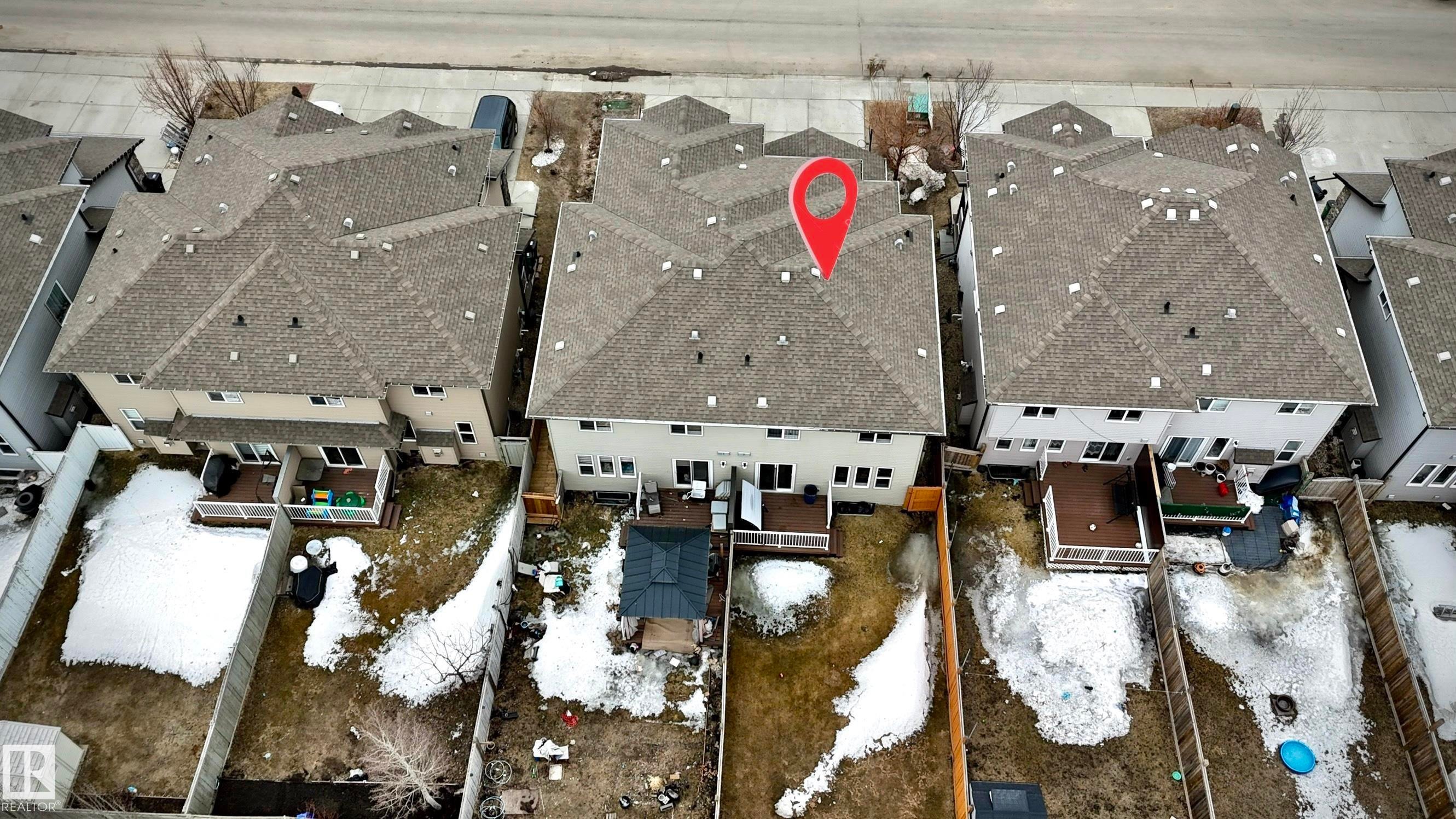 Rear property exterior featuring a multi-level deck, fenced yard, and multi-pane windows - 2314 22 Avenue, Edmonton, AB - Photo Showing Other Room