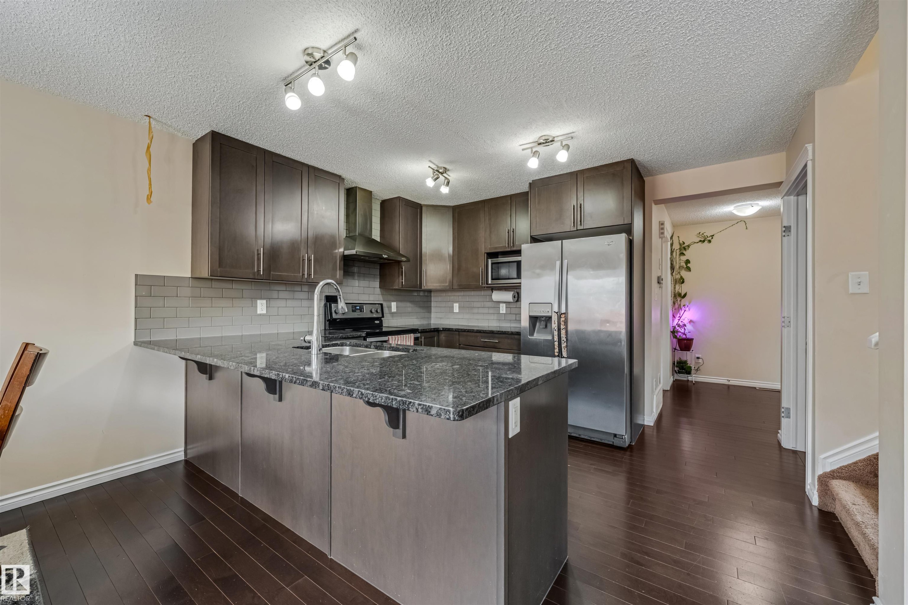 Kitchen featuring a central island with an undermount double sink and a gooseneck faucet - 2314 22 Avenue, Edmonton, AB - Indoor Photo Showing Kitchen With Double Sink With Upgraded Kitchen