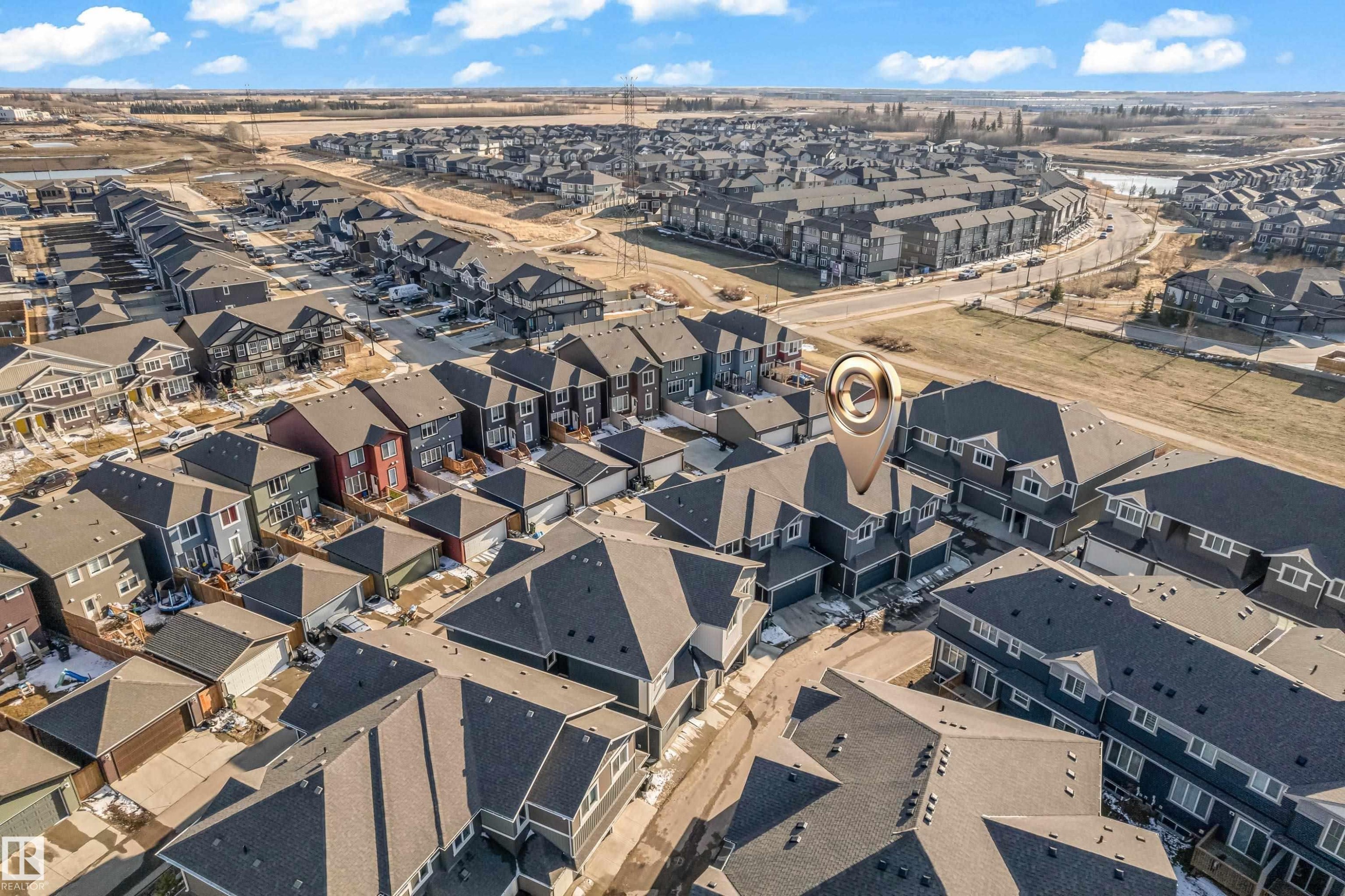 Aerial perspective showcasing a residential development with individual houses and multi-unit buildings - 41 603 Orchards Boulevard, Edmonton, AB - Outdoor With View