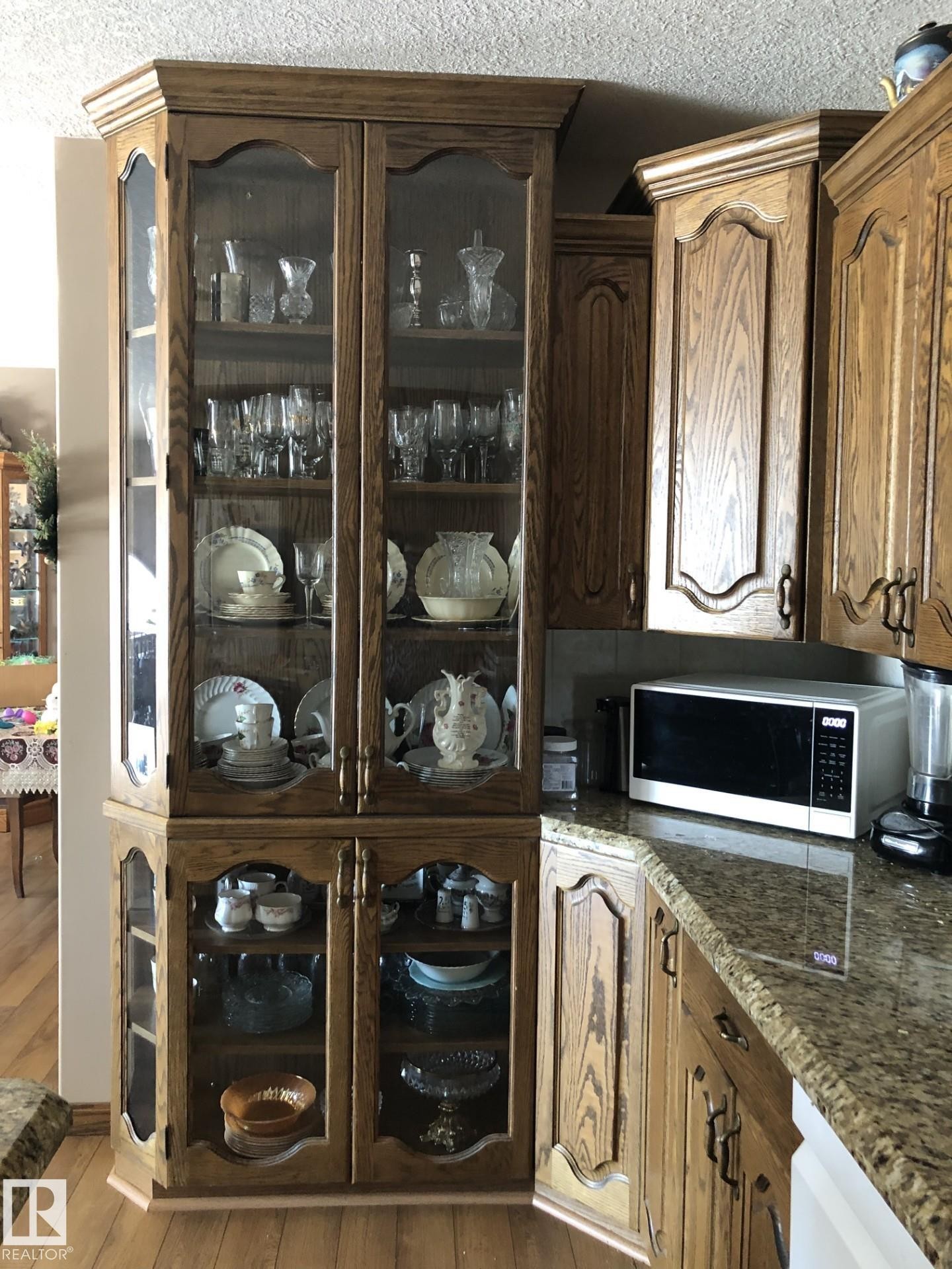 Custom built-in display cabinetry featuring glass-front doors and wood-finish construction - 123064 Hwy 45, Rural Two Hills County, AB