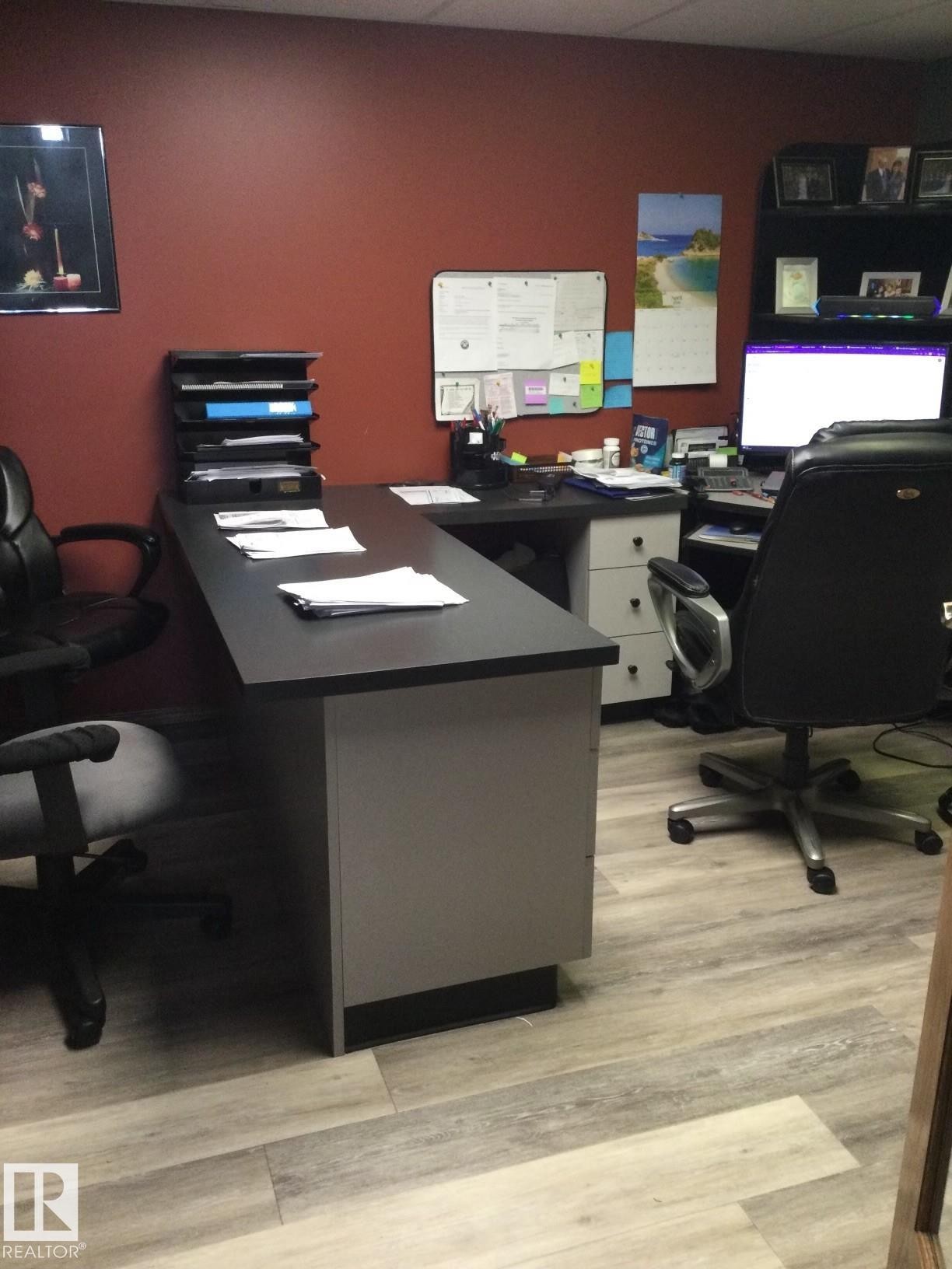 Office area featuring an L-shaped desk with a dark countertop and light grey base - 123064 Hwy 45, Rural Two Hills County, AB