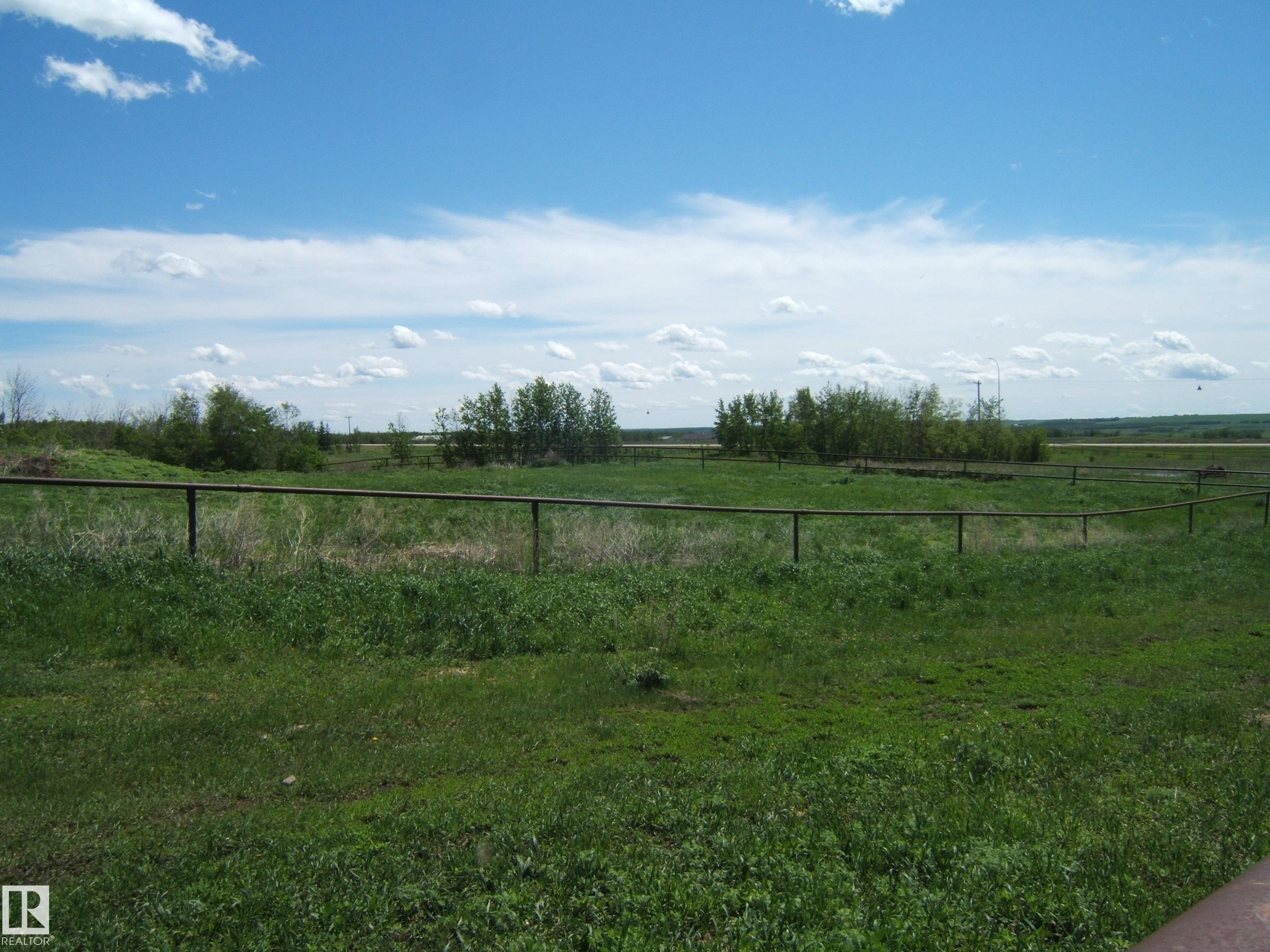 Expansive open land featuring green vegetation and distant treelines - 123064 Hwy 45, Rural Two Hills County, AB