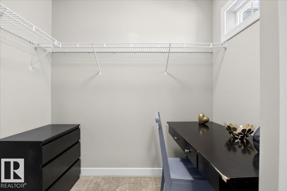 Walk-in closet featuring wire shelving, a window for natural light, and neutral wall paint - 18 6032 38 Avenue, Edmonton, AB - Indoor With Storage