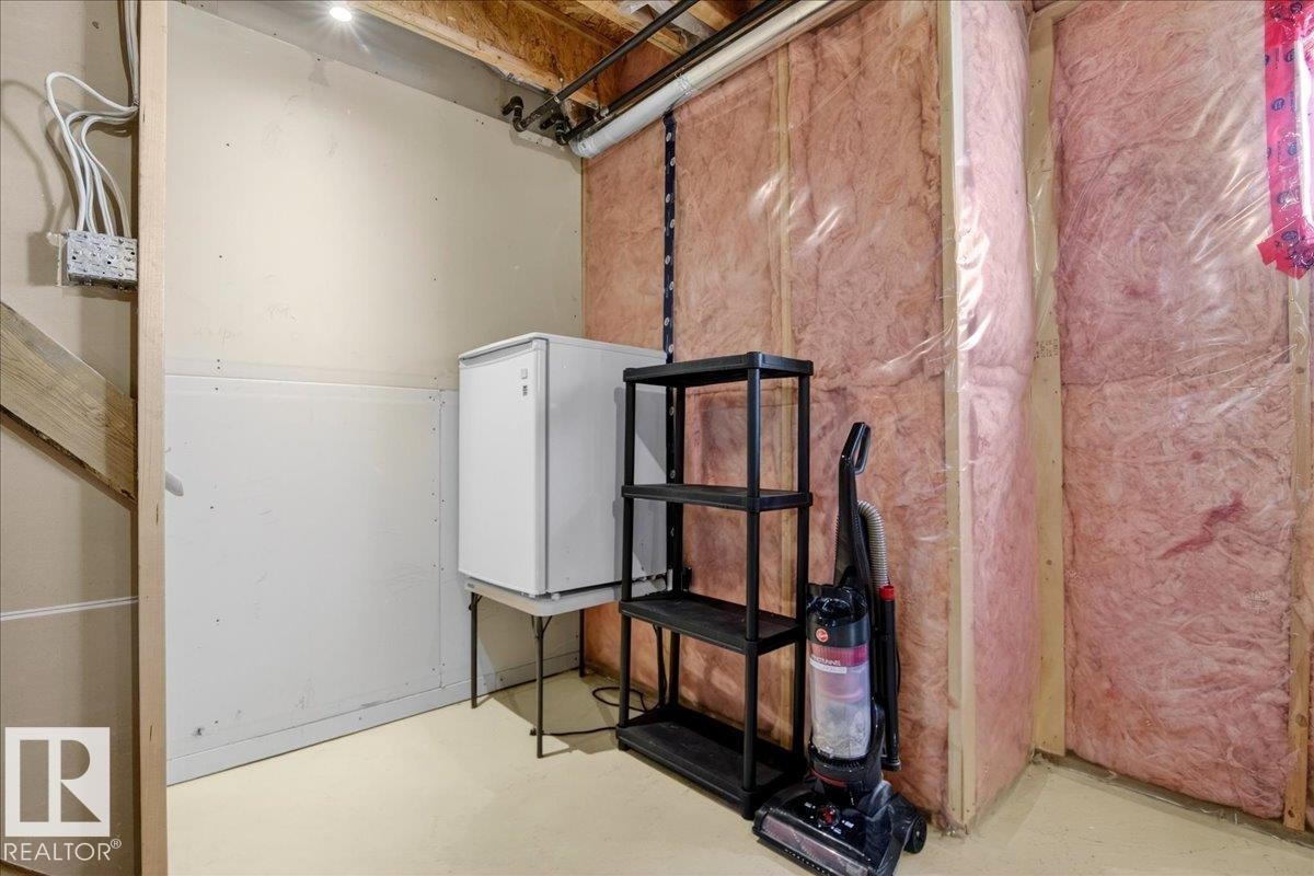 Unfinished basement area with exposed insulation, unfinished walls, and visible ceiling joists - 18 6032 38 Avenue, Edmonton, AB - Indoor Photo Showing Basement