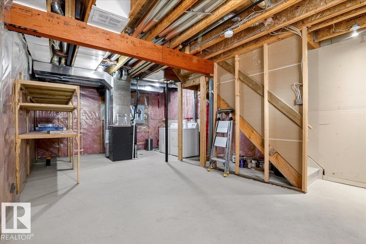 Spacious unfinished basement featuring exposed wood joists, concrete flooring, and visible ductwork - 18 6032 38 Avenue, Edmonton, AB - Indoor Photo Showing Basement