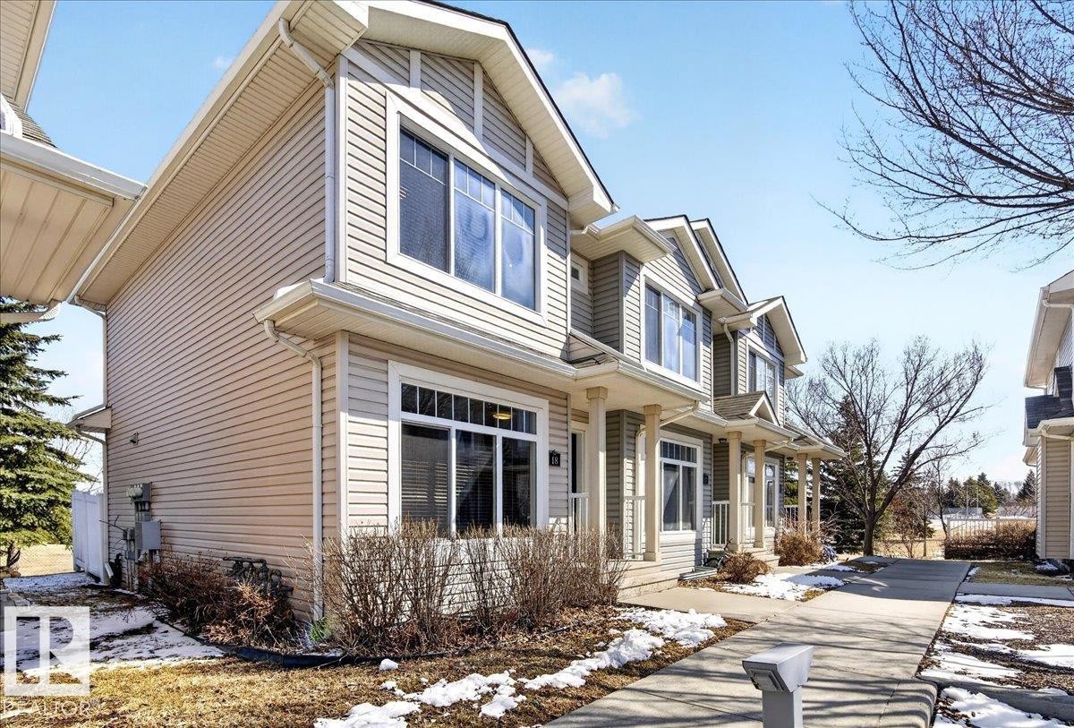 Townhome exterior featuring horizontal siding and gabled rooflines - 18 6032 38 Avenue, Edmonton, AB - Outdoor