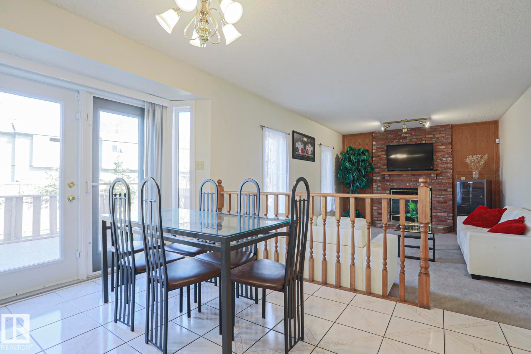 Dining area featuring ceramic tile flooring and glass-paneled patio doors - 2433 89 Street, Edmonton, AB - Indoor