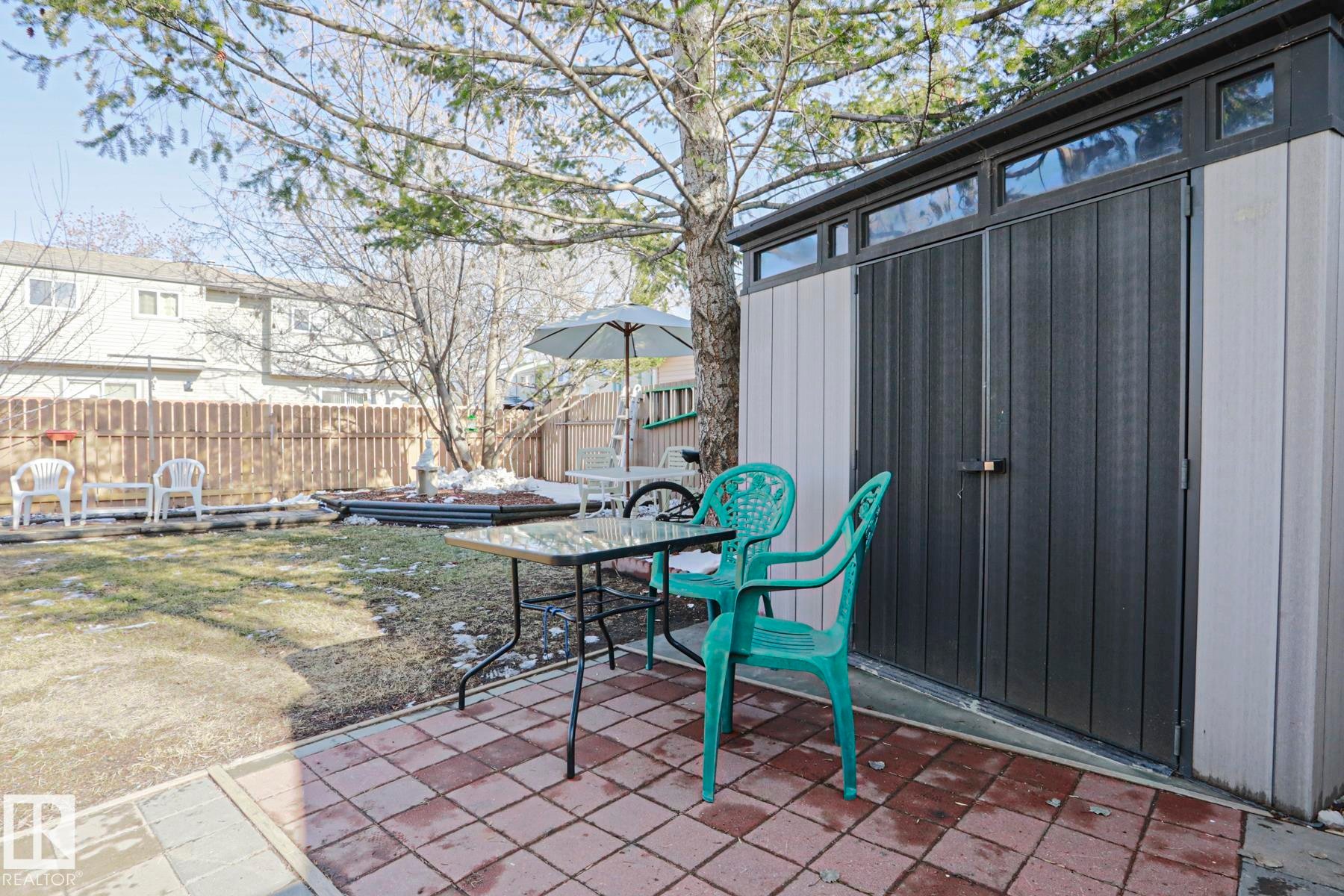 Backyard patio featuring brick pavers and an adjacent storage shed - 2433 89 Street, Edmonton, AB - Outdoor