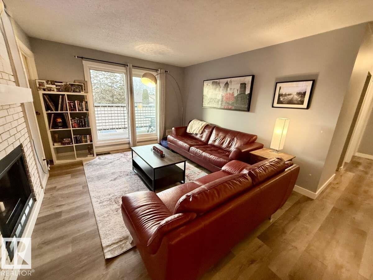 205 60 Alpine Place, St. Albert, AB - Indoor Photo Showing Living Room With Fireplace