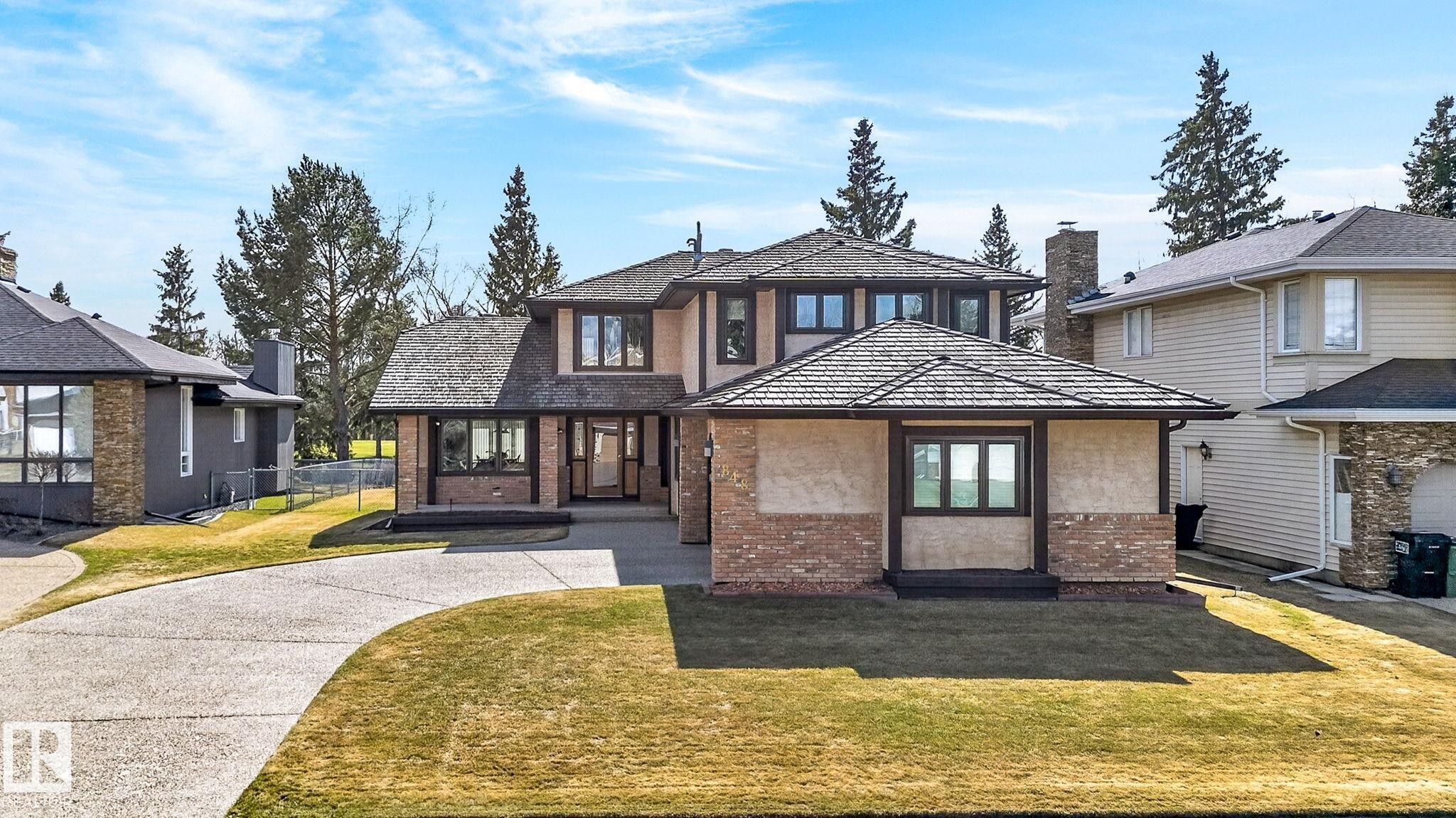 Two-story residence featuring a shingle roof, stone and stucco exterior, and multiple windows with dark trim - 848 Wheeler Road W, Edmonton, AB - Outdoor With Facade