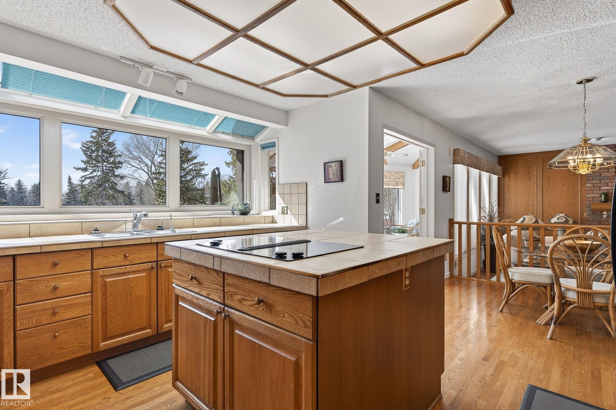 Kitchen featuring an integrated cooktop on a tiled island - 848 Wheeler Road W, Edmonton, AB - Indoor