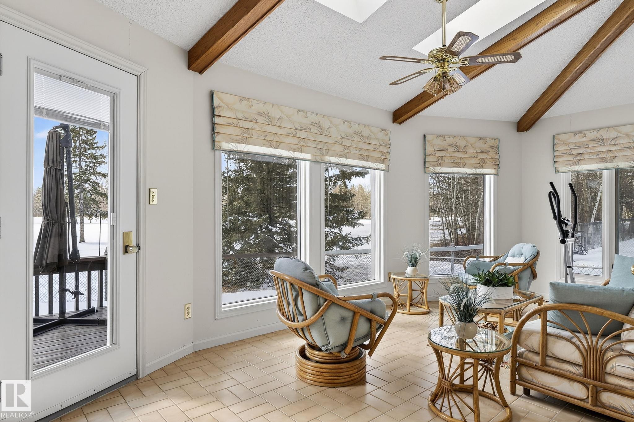 Sunroom with exposed wood beams, skylights, and multiple windows - 848 Wheeler Road W, Edmonton, AB - Indoor Photo Showing Living Room