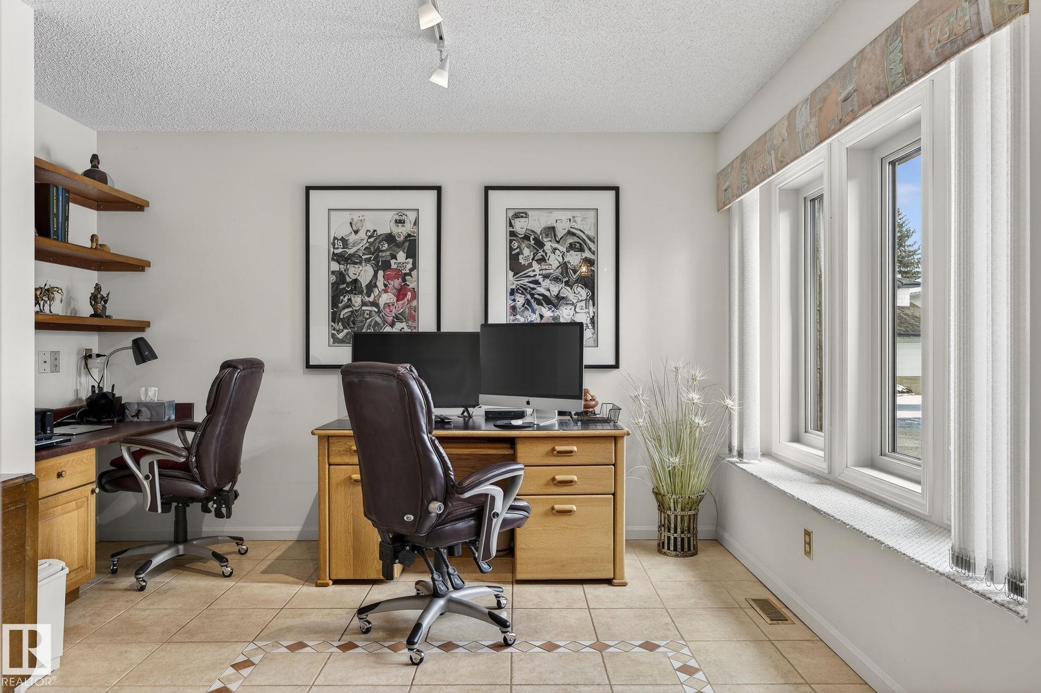 Dedicated workspace featuring multiple workstations, recessed shelving, and a triple window assembly - 848 Wheeler Road W, Edmonton, AB - Indoor Photo Showing Office