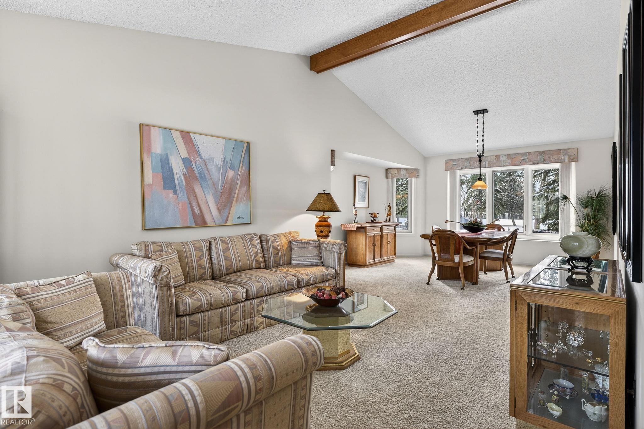 Vaulted ceiling with exposed wood beam and textured finish - 848 Wheeler Road W, Edmonton, AB - Indoor Photo Showing Living Room