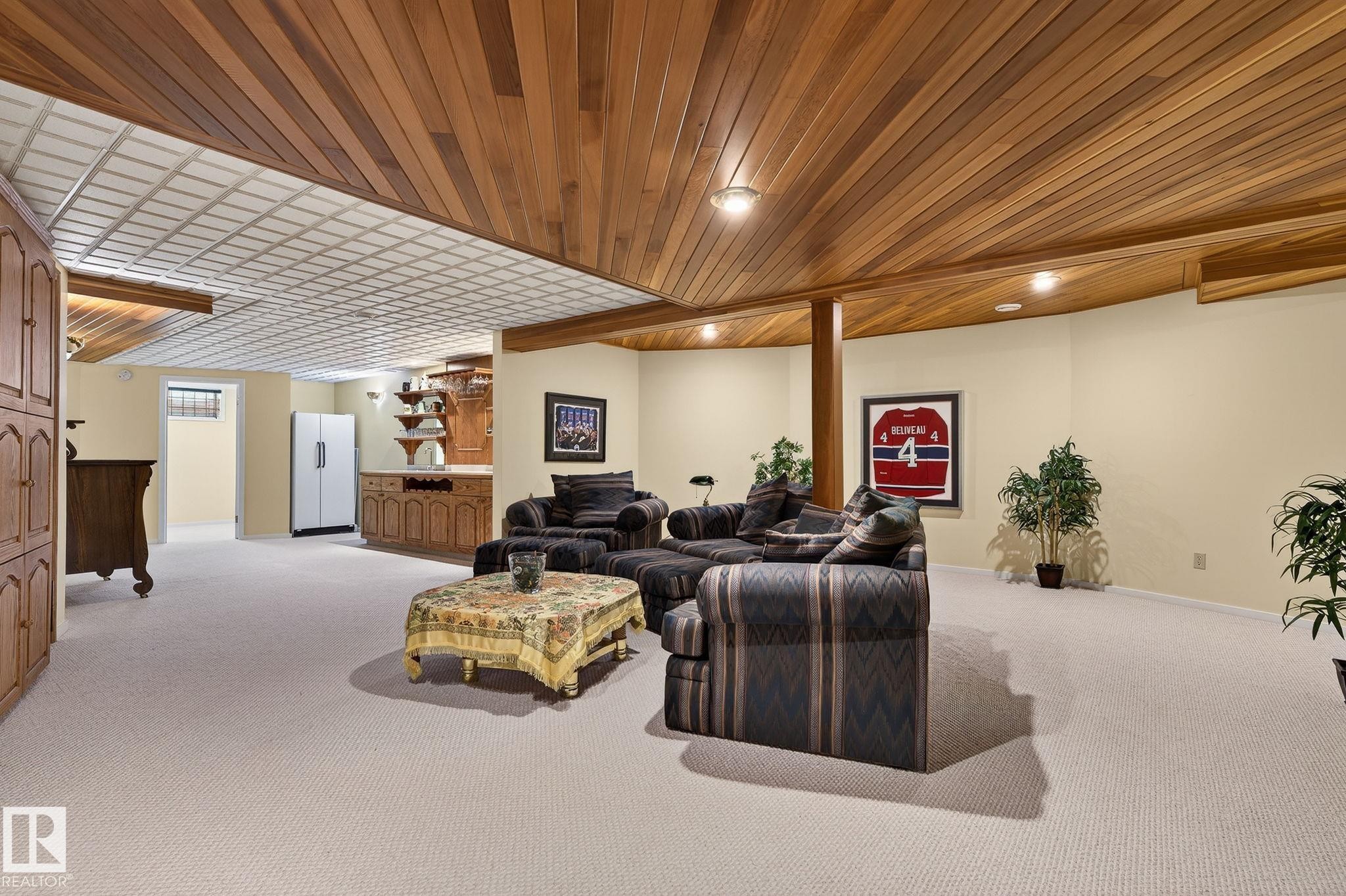 Finished lower level featuring a wood-panel ceiling, recessed lighting, and light-toned carpeting - 848 Wheeler Road W, Edmonton, AB - Indoor