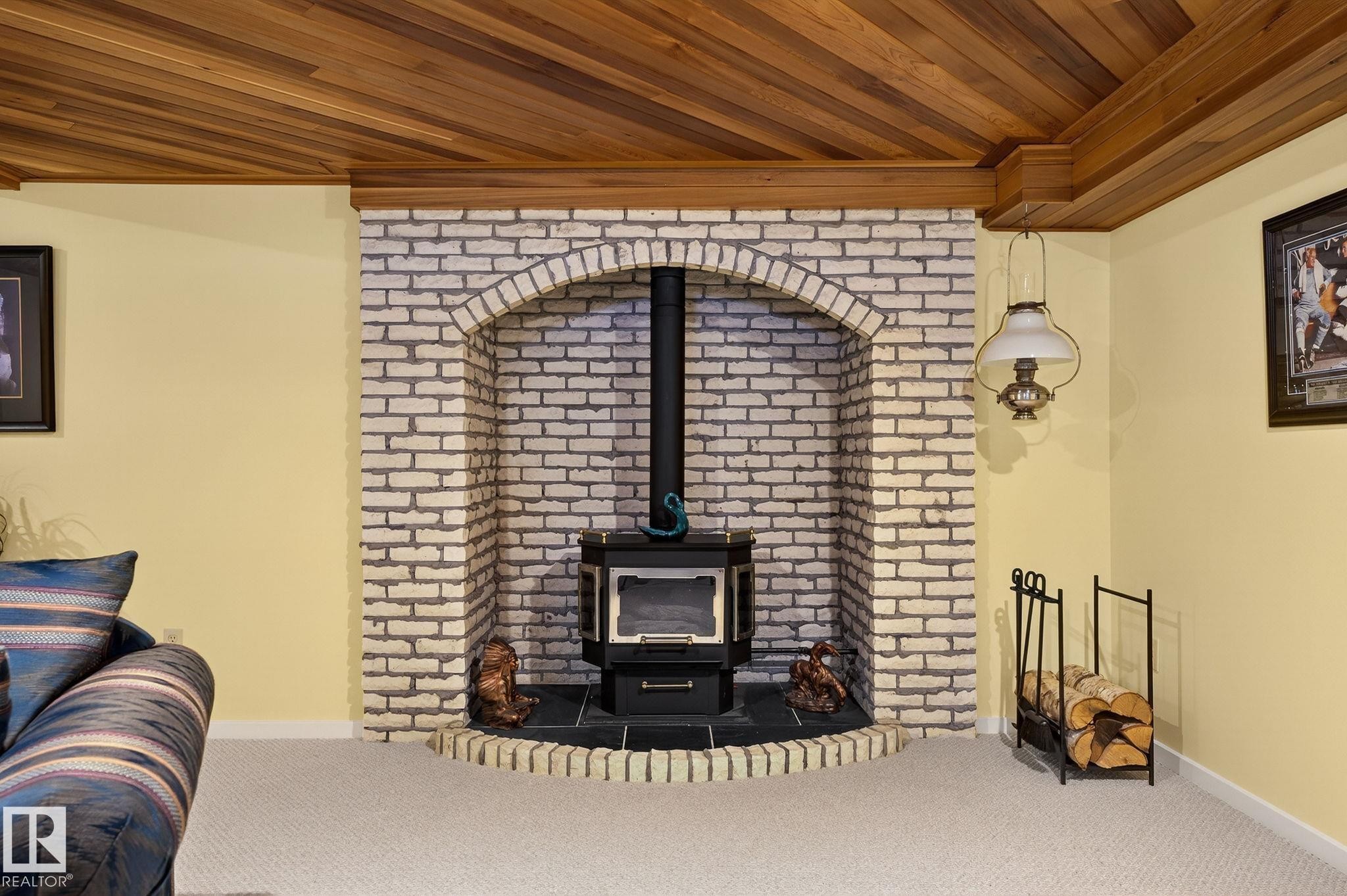 Wood plank ceiling with a light wood cornice - 848 Wheeler Road W, Edmonton, AB - Indoor With Fireplace