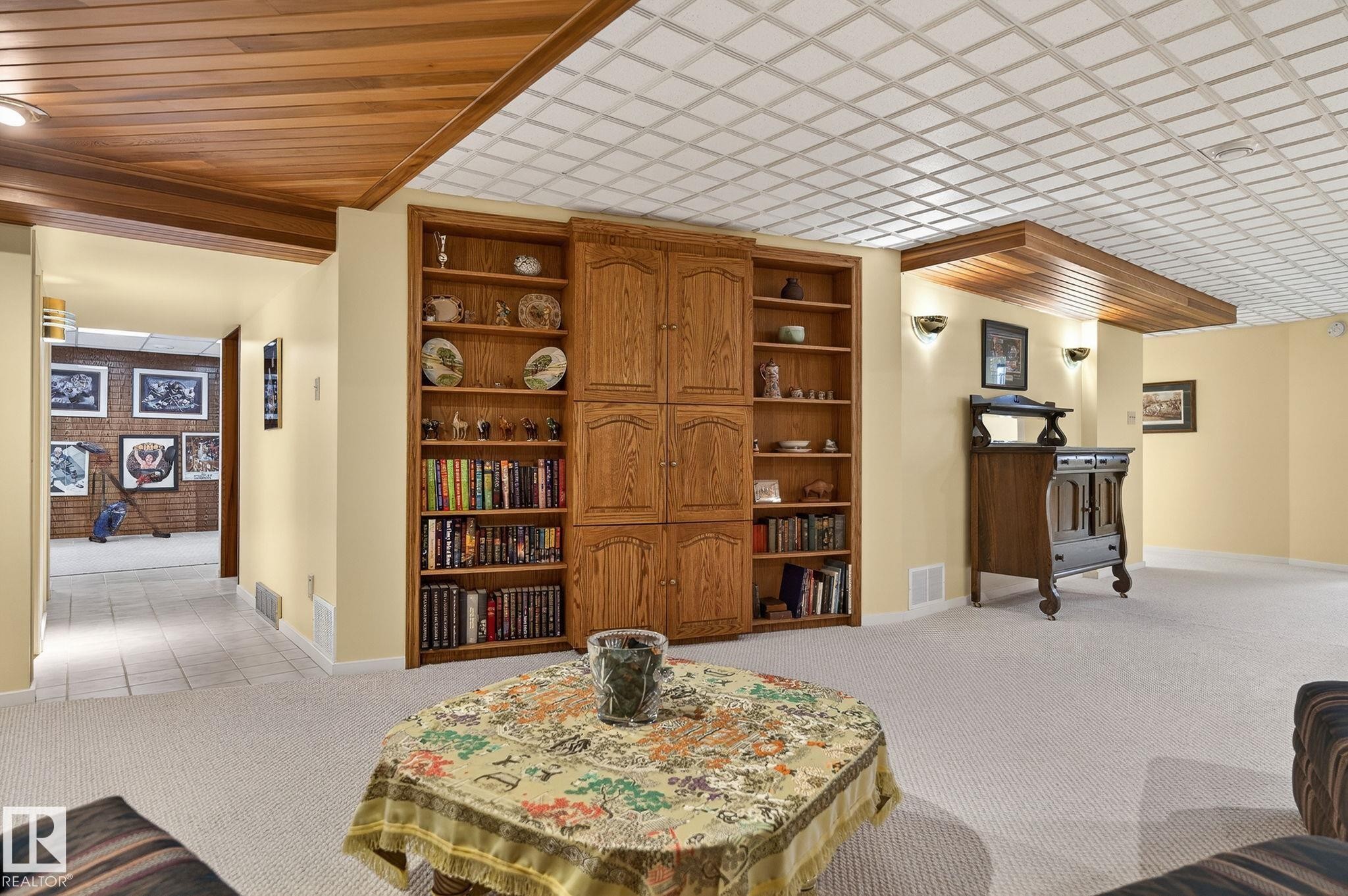 Integrated wood shelving and cabinetry against light yellow walls - 848 Wheeler Road W, Edmonton, AB - Indoor