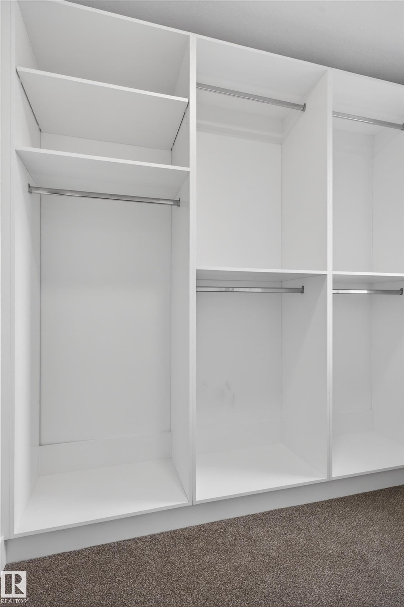 Built-in white cabinetry featuring multiple shelving units and integrated hanging rods - 45 River Birch, St. Albert, AB - Indoor With Storage