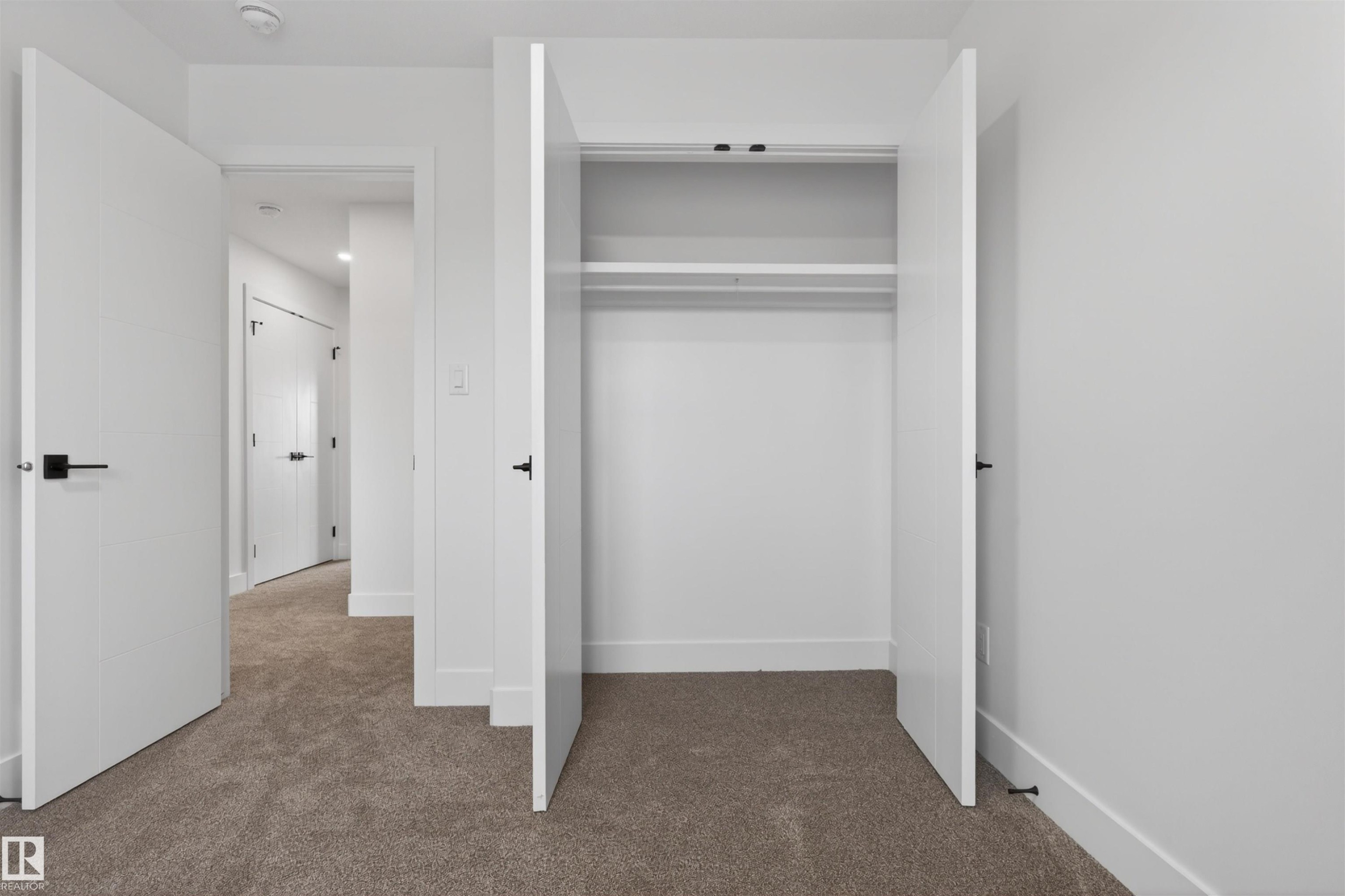 Open closet with integrated shelving and hanging rod - 45 River Birch, St. Albert, AB - Indoor Photo Showing Other Room