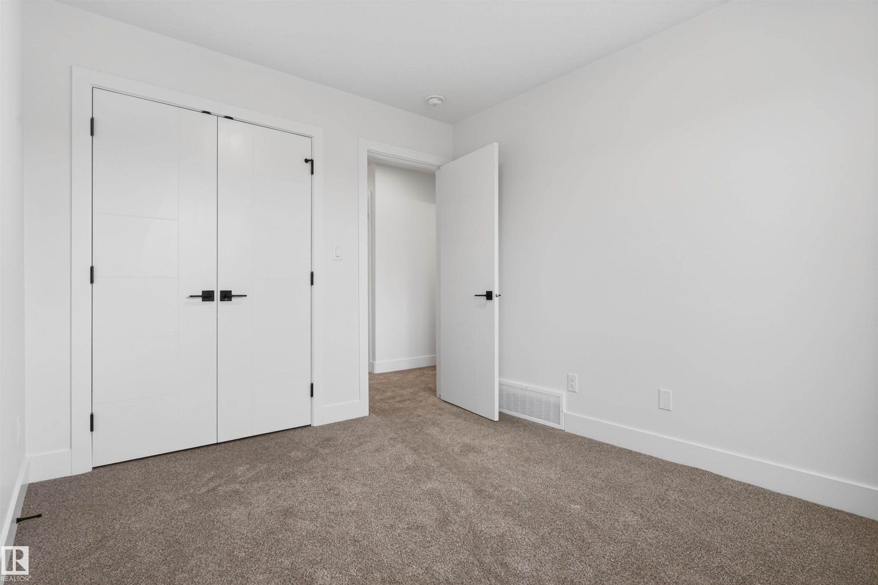 Neutral-toned carpeting, white walls, and bright white trim - 45 River Birch, St. Albert, AB - Indoor Photo Showing Other Room