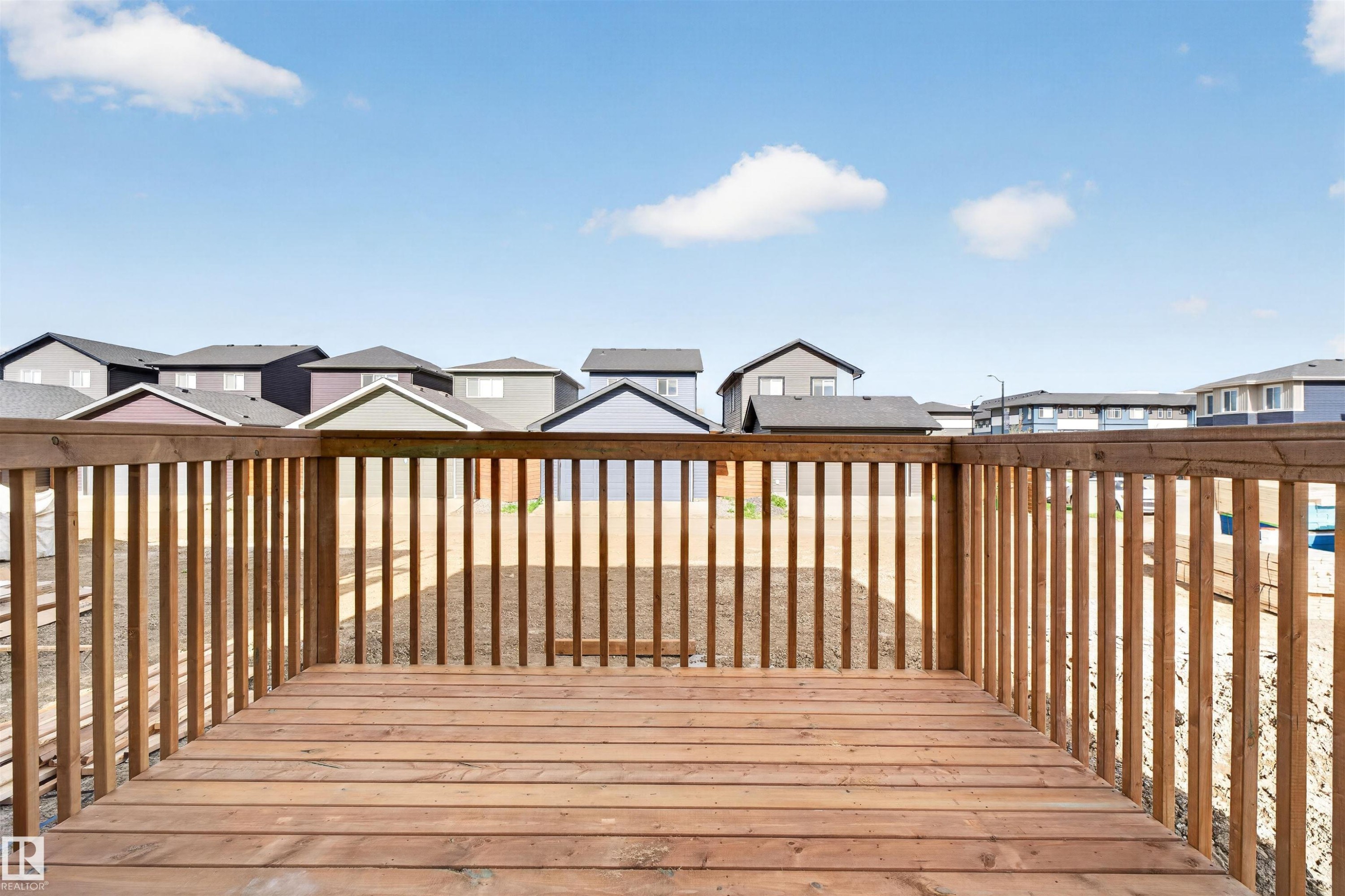 Expansive outdoor deck featuring natural wood planks and a matching wood railing - 45 River Birch, St. Albert, AB - Outdoor