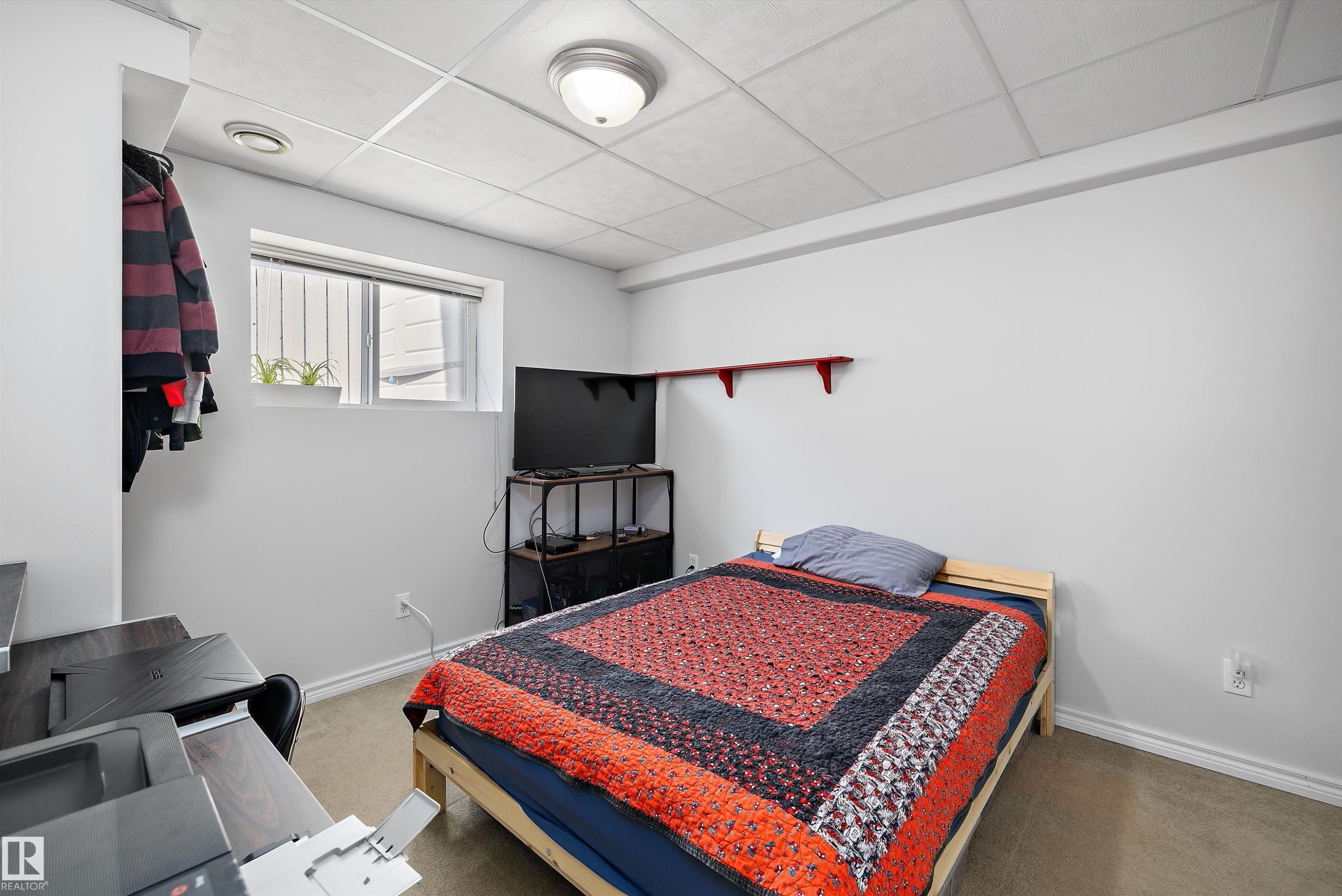 Bedroom featuring a window, neutral-toned walls, and a drop ceiling with recessed lighting - 1811 37 Avenue, Edmonton, AB - Indoor Photo Showing Bedroom