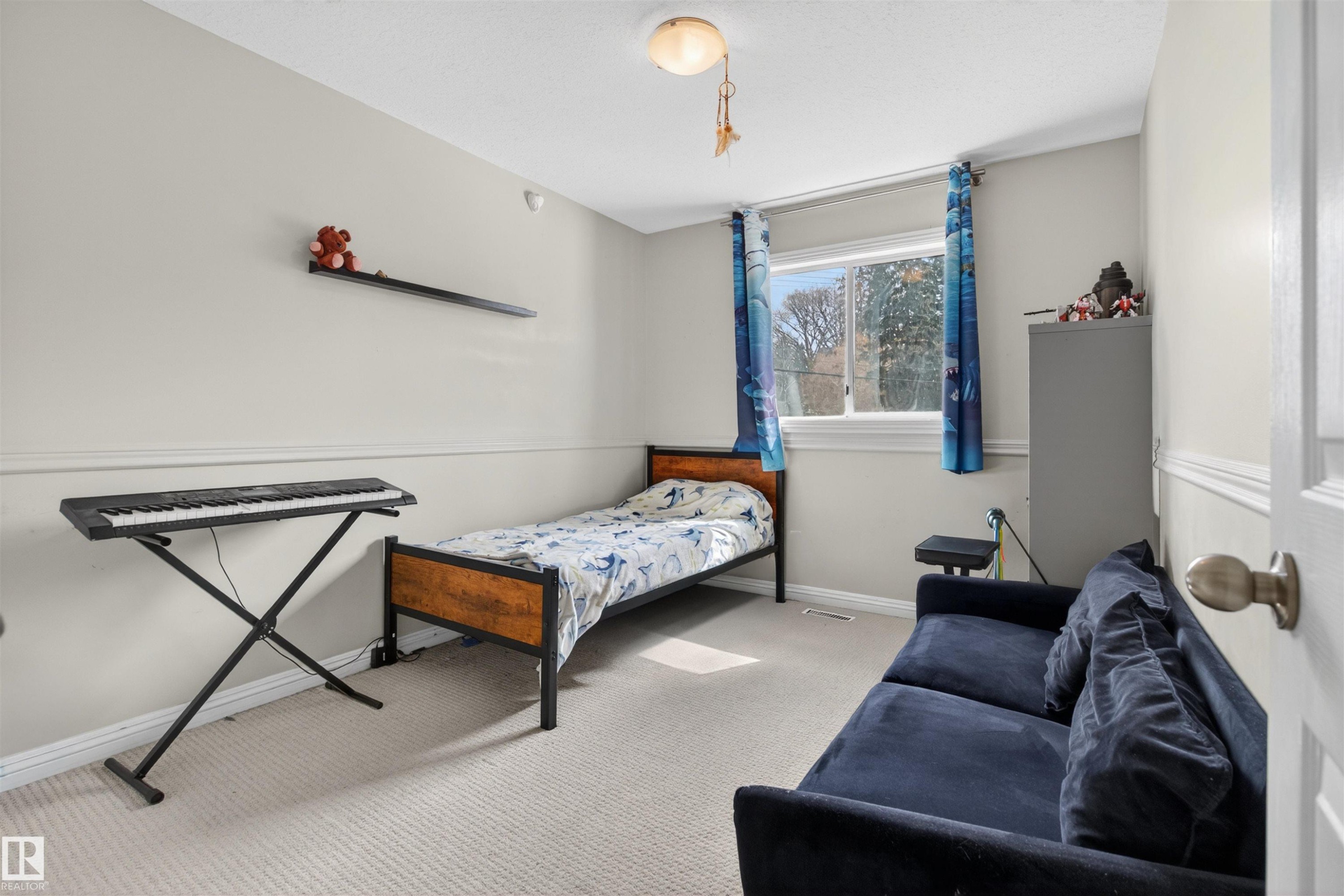 This room features light-colored walls, carpeted flooring, and a window providing natural light - 2 Sturgeon Road, St. Albert, AB - Indoor