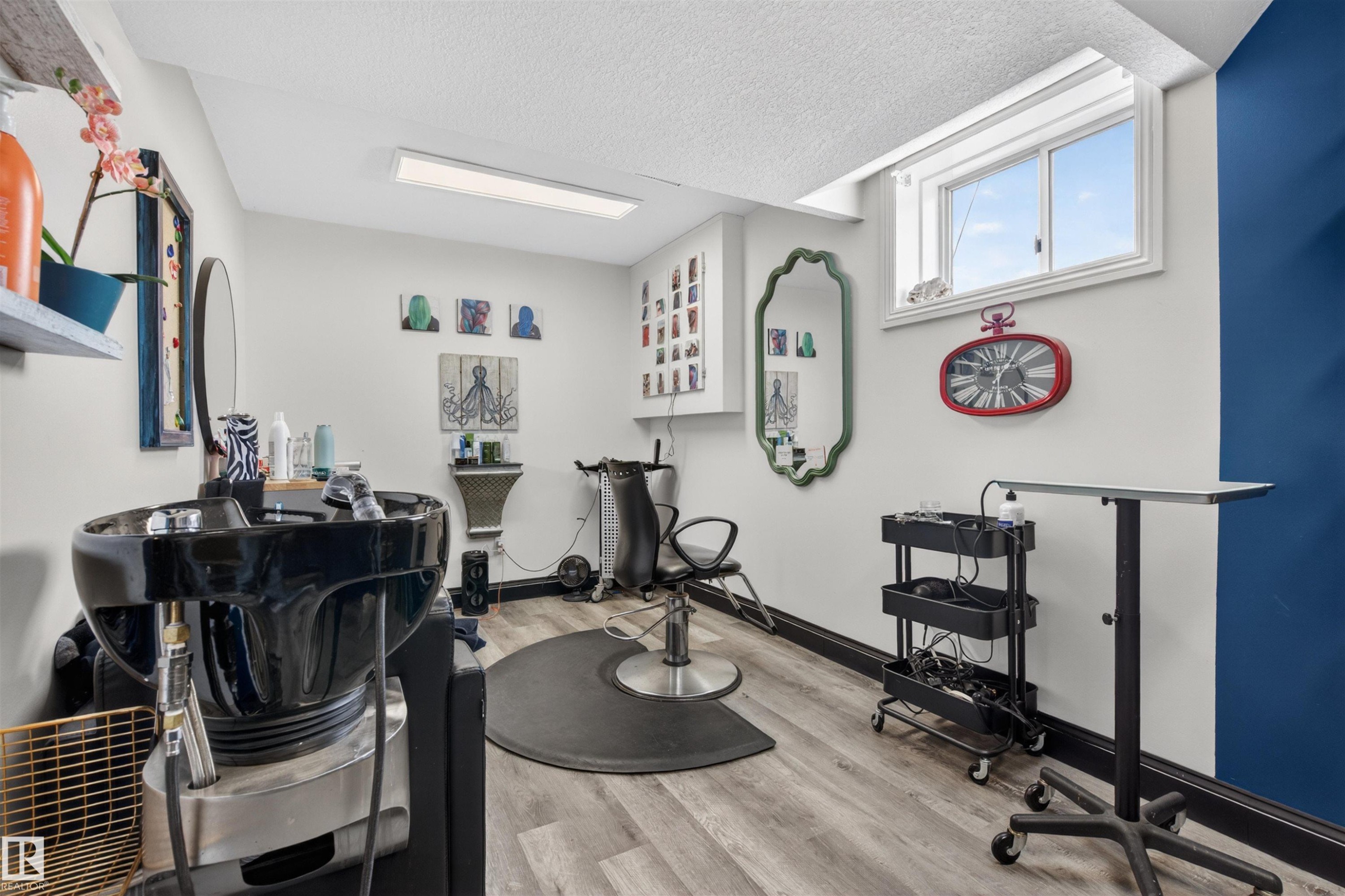 This versatile room features light-toned flooring, a window providing natural light, and a modern ceiling light fixture - 2 Sturgeon Road, St. Albert, AB - Indoor