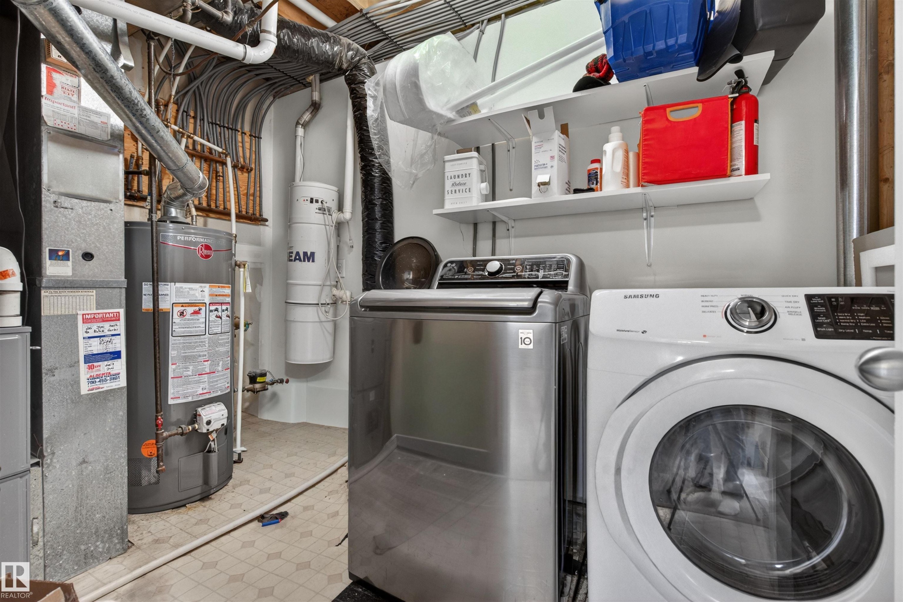 This utility area features a washing machine, a dryer, shelving, and a water heater - 2 Sturgeon Road, St. Albert, AB - Indoor Photo Showing Laundry Room