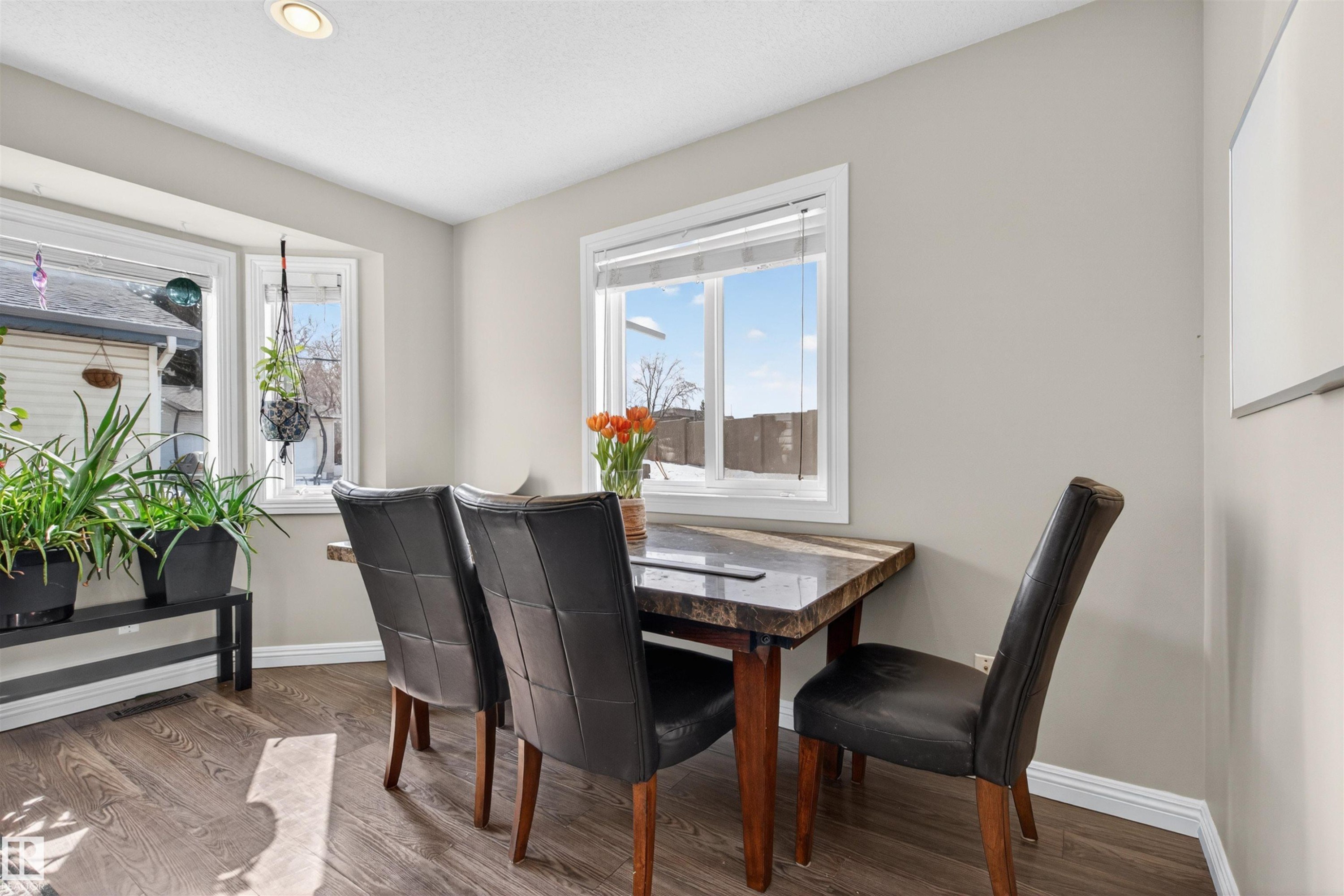 This dining area features wood-look flooring, neutral wall tones, and recessed lighting - 2 Sturgeon Road, St. Albert, AB - Indoor Photo Showing Dining Room
