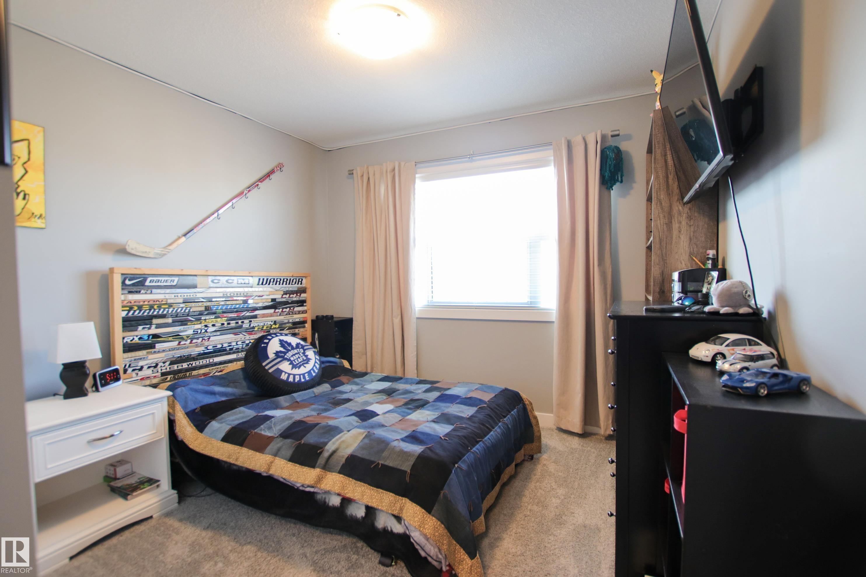 Bright room featuring a ceiling light fixture, neutral wall paint, and soft carpet flooring - 3805 170A Avenue, Edmonton, AB - Indoor Photo Showing Bedroom
