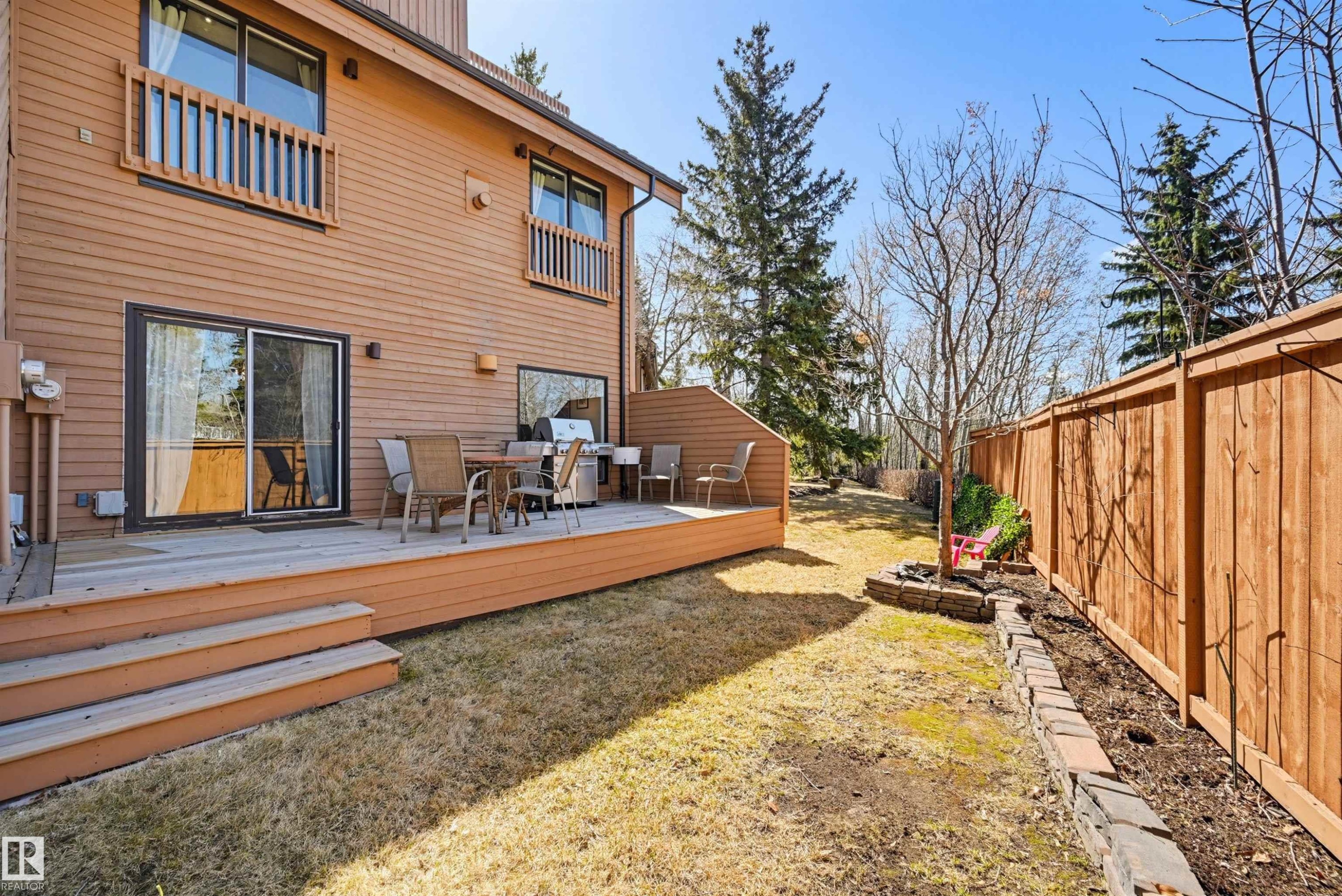Spacious wooden deck with multiple steps and sliding glass door access - 139 Wolf Willow Crescent, Edmonton, AB - Outdoor With Deck Patio Veranda With Exterior