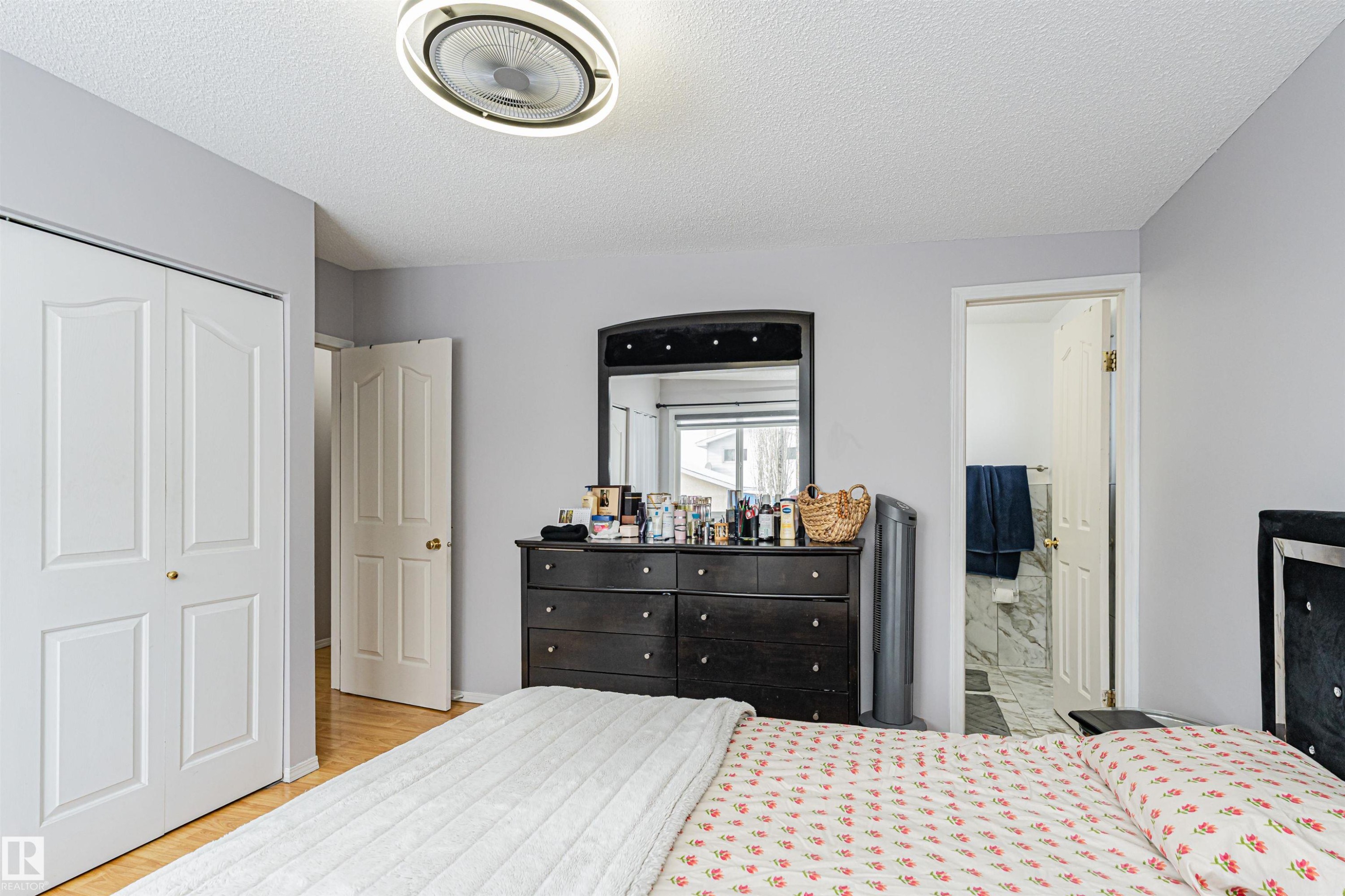 This room features light-colored walls and a ceiling fan with integrated lighting - 10412 39 Avenue, Edmonton, AB - Indoor Photo Showing Bedroom