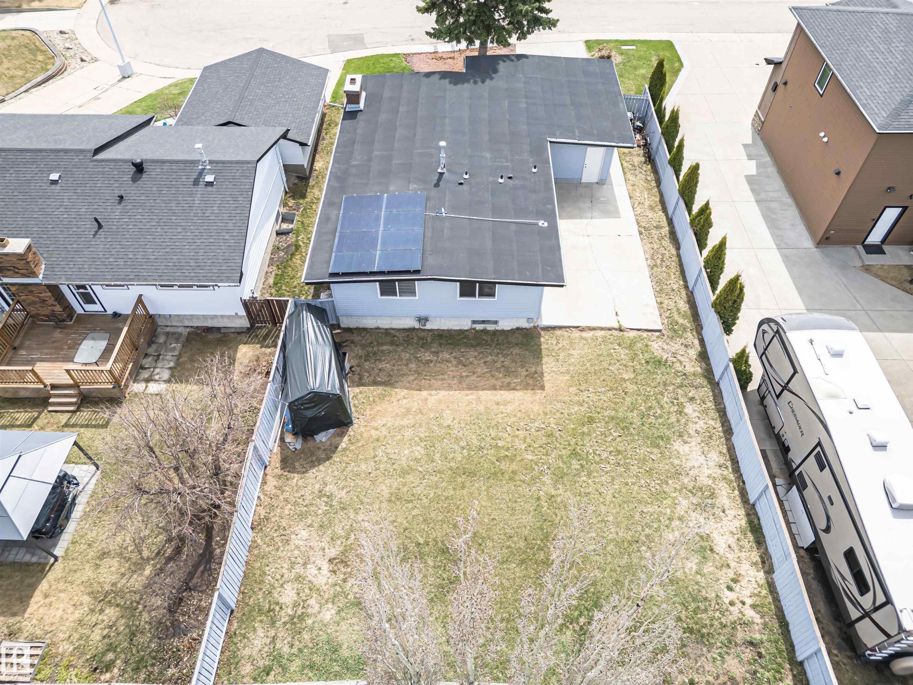 Rear exterior with solar panels, a paved patio, and a fenced yard - 10412 39 Avenue, Edmonton, AB - Outdoor
