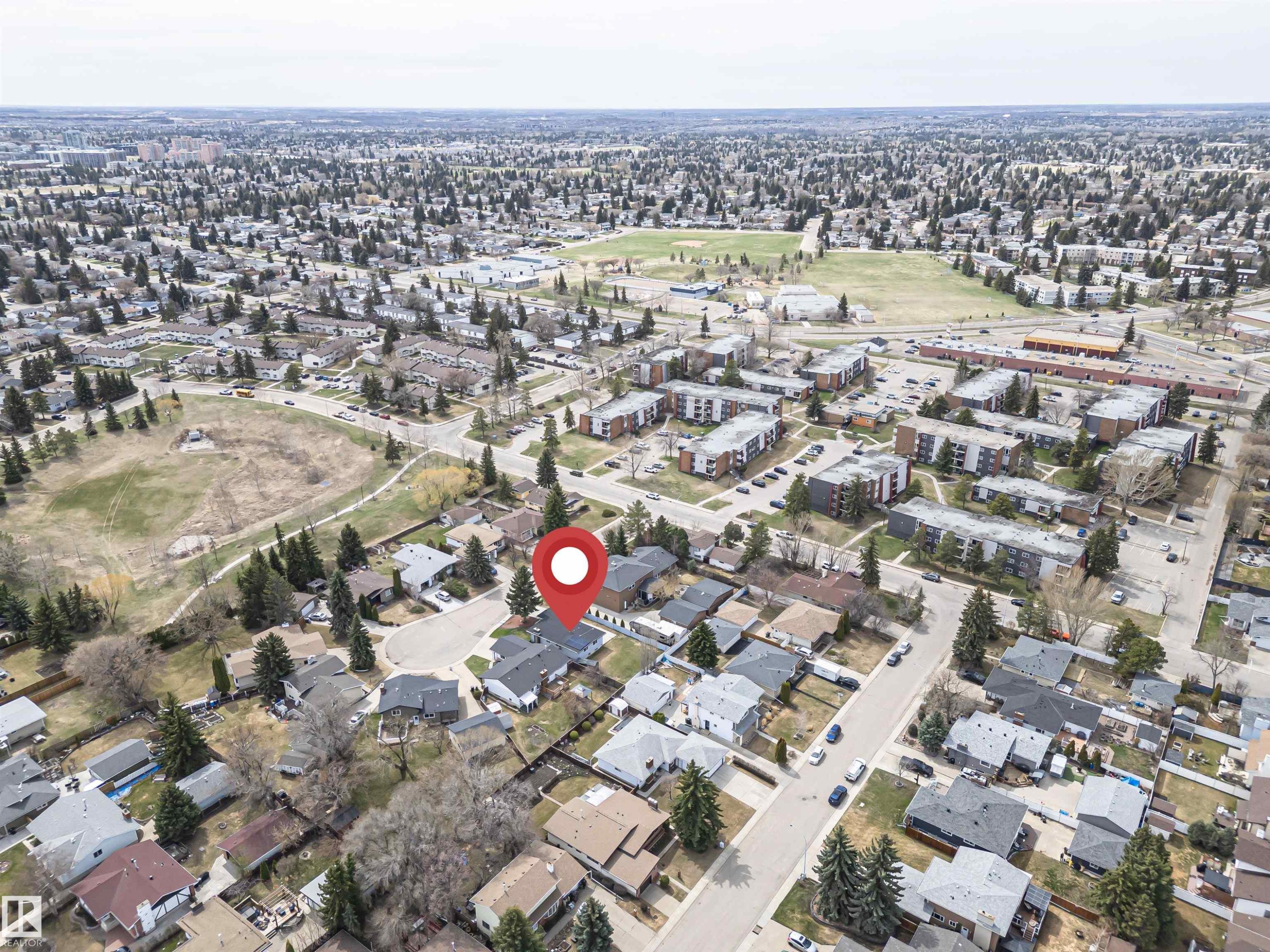 Aerial perspective showcasing a residential area with varied housing styles, mature trees, and nearby open green spaces - 10412 39 Avenue, Edmonton, AB - Outdoor With View
