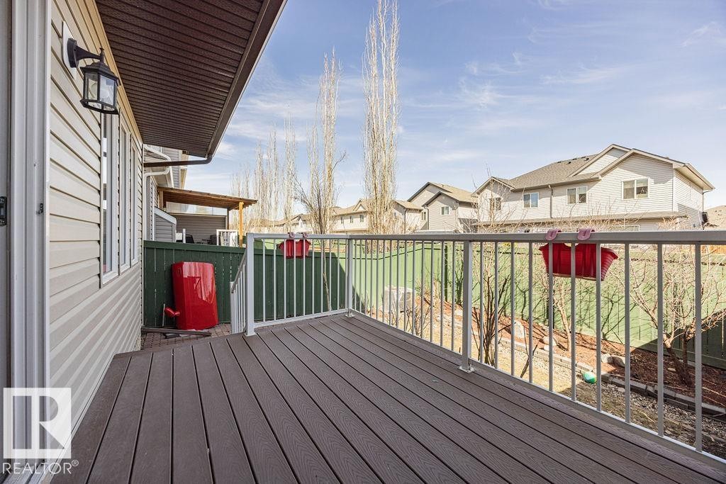 Elevated deck featuring composite decking and white metal railings - 14 9350 211 Street, Edmonton, AB - Outdoor With Deck Patio Veranda With Exterior