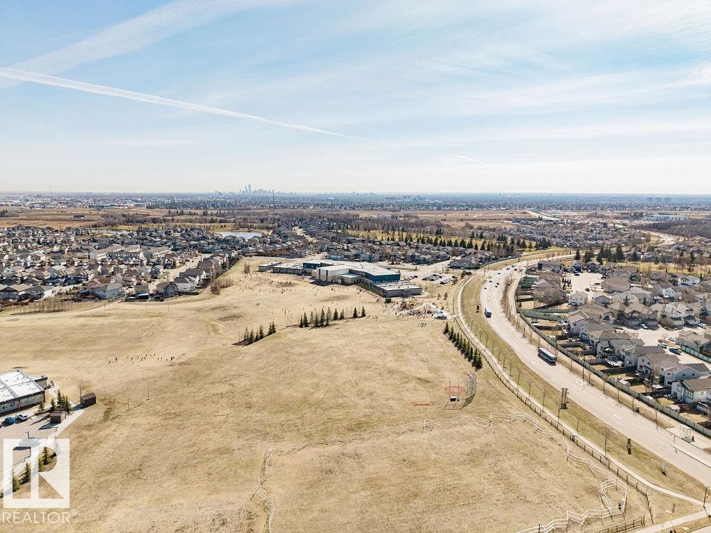 Expansive land parcel offering significant development potential, bordered by established residential areas and a prominent roadway - 14 9350 211 Street, Edmonton, AB - Outdoor With View