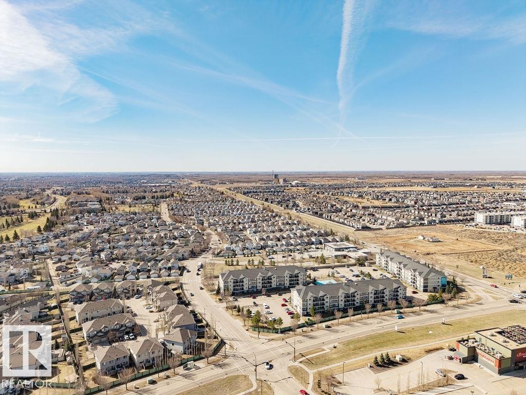 Aerial perspective showcasing a developed residential area with single-family homes and multi-story apartment buildings - 14 9350 211 Street, Edmonton, AB - Outdoor With View
