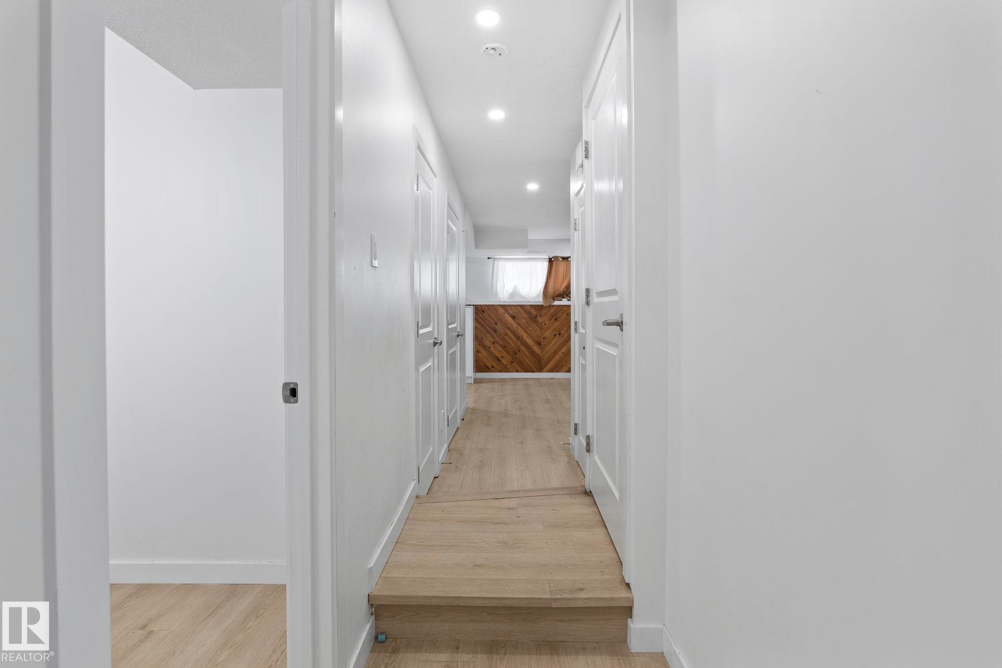 Bright hallway featuring recessed lighting and wood-finish flooring - 1566 Lakewood Road Nw, Edmonton, AB - Indoor Photo Showing Other Room
