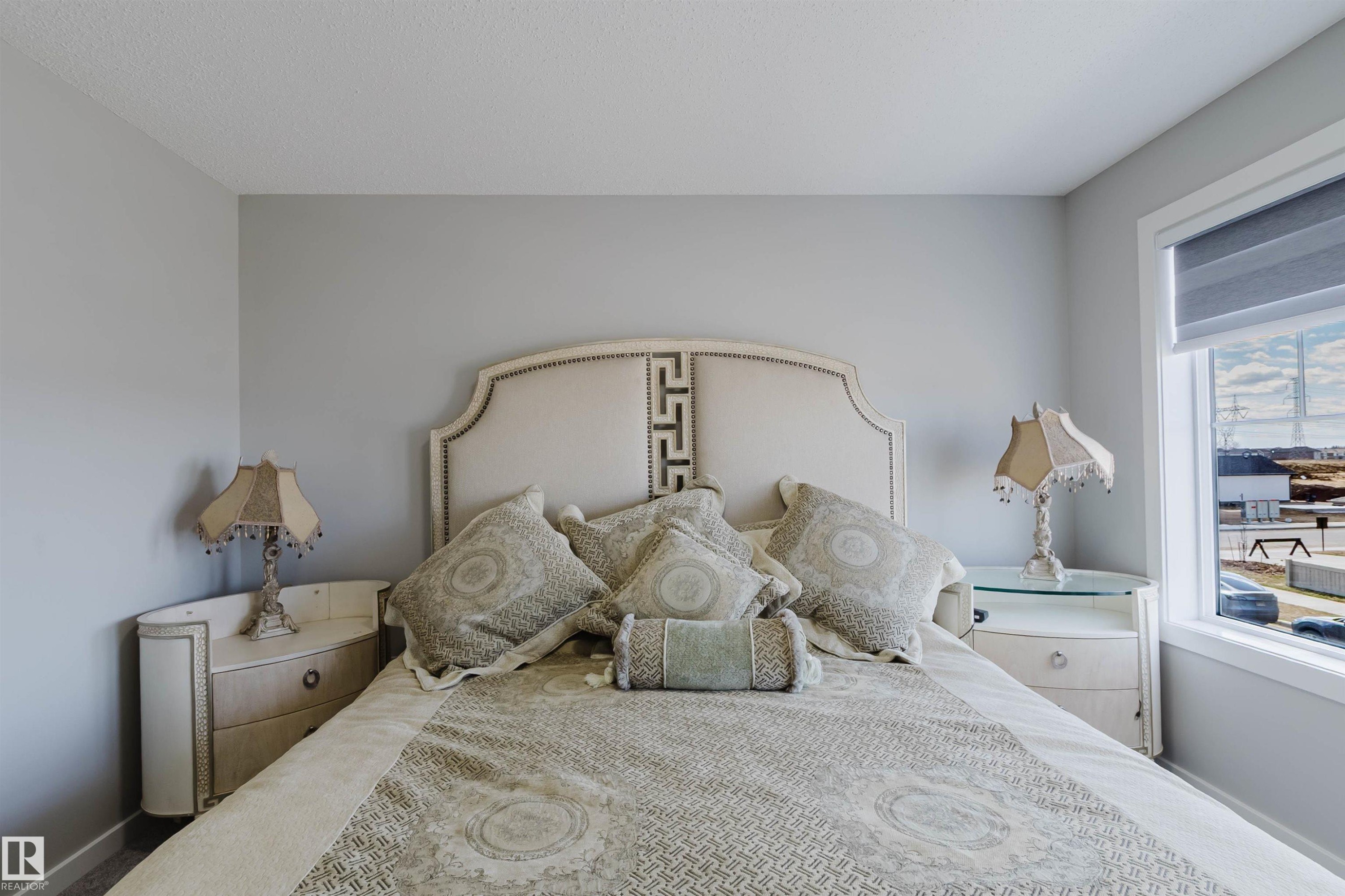 Soft gray wall tones with an upholstered headboard featuring nailhead trim - 343 Edgemont Drive, Edmonton, AB - Indoor Photo Showing Bedroom