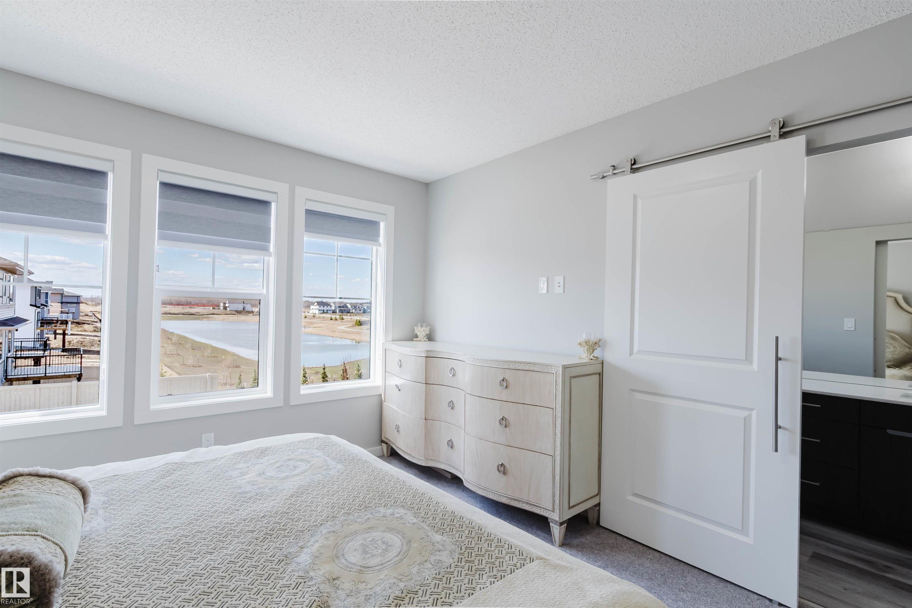 Three large windows with roller shades offer expansive outdoor scenery - 343 Edgemont Drive, Edmonton, AB - Indoor Photo Showing Bedroom