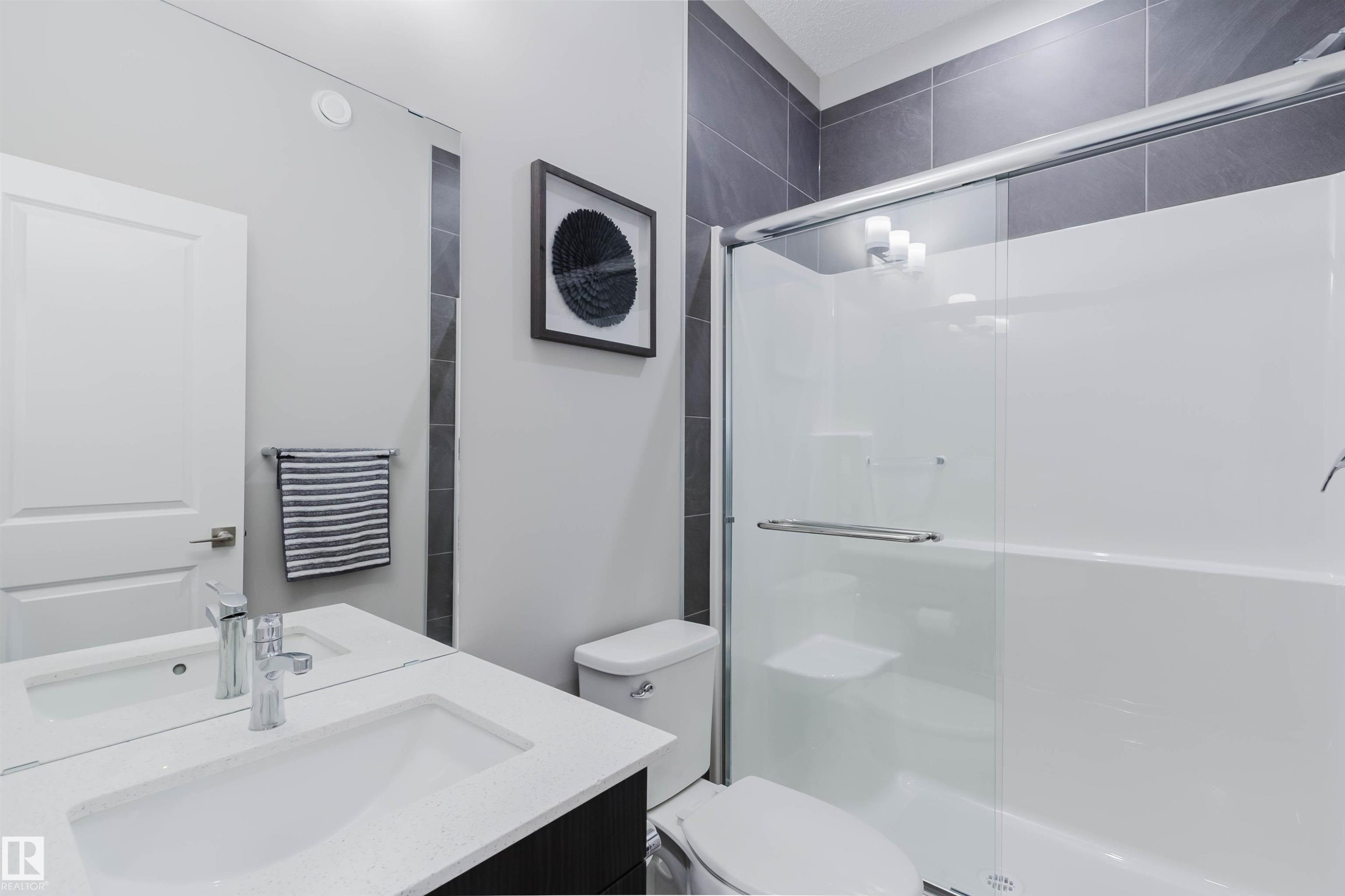 Contemporary bathroom featuring a vanity with an integrated sink, polished chrome faucet, and a large wall mirror - 343 Edgemont Drive, Edmonton, AB - Indoor Photo Showing Bathroom