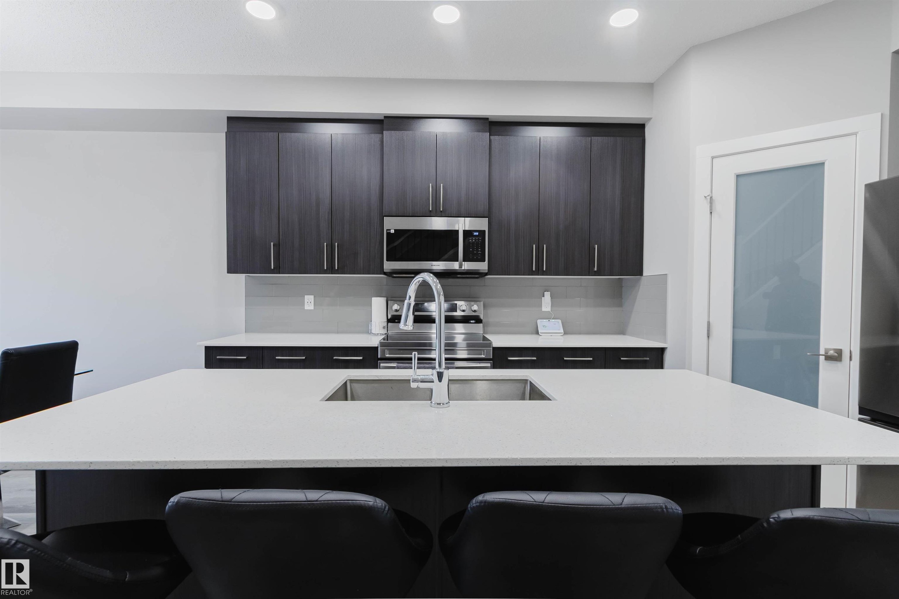 Kitchen island with white countertop and integrated sink - 343 Edgemont Drive, Edmonton, AB - Indoor Photo Showing Kitchen With Upgraded Kitchen