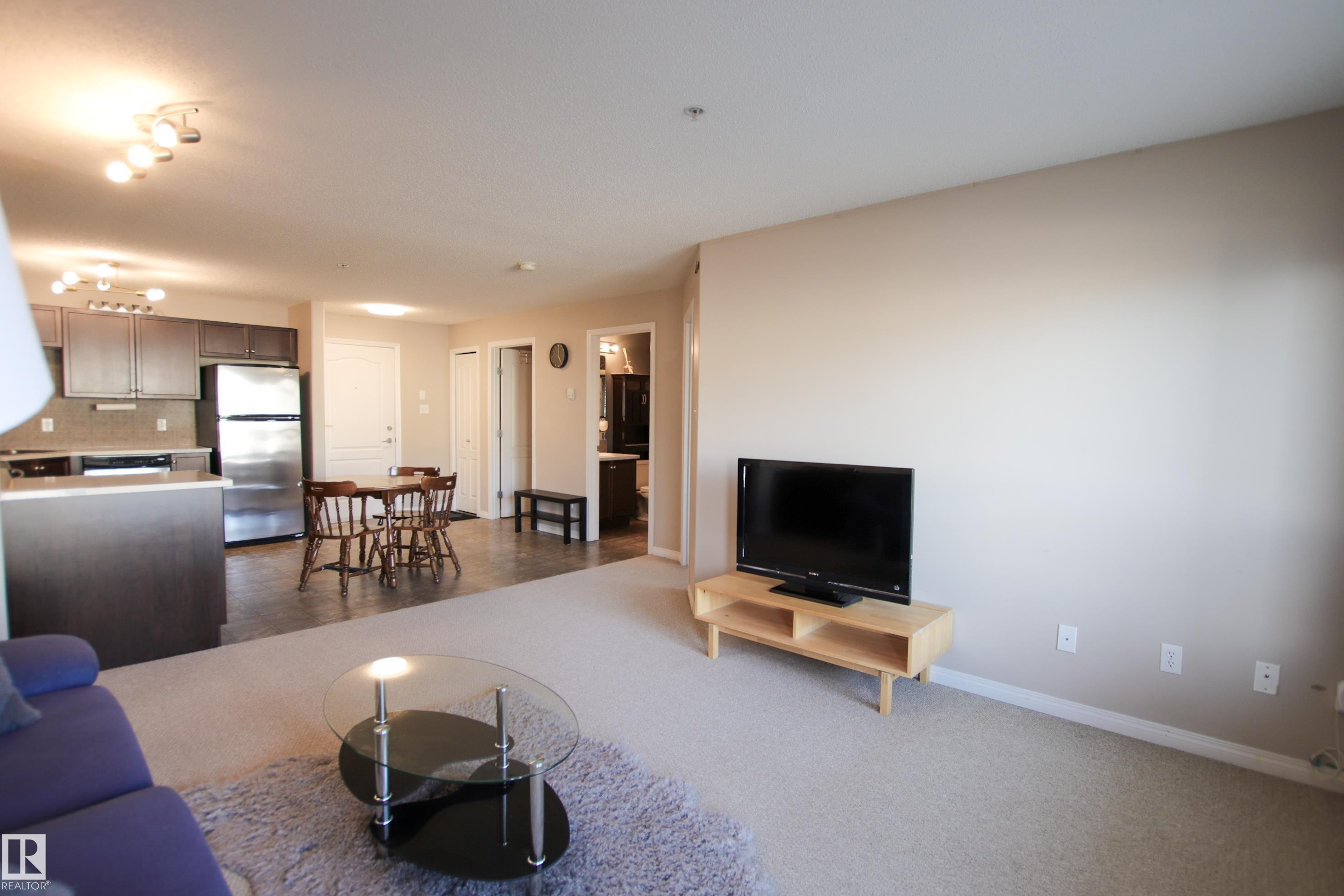 Open-concept living space with light-toned walls and carpet flooring - 7206 7327 South Terwillegar Drive, Edmonton, AB - Indoor Photo Showing Living Room