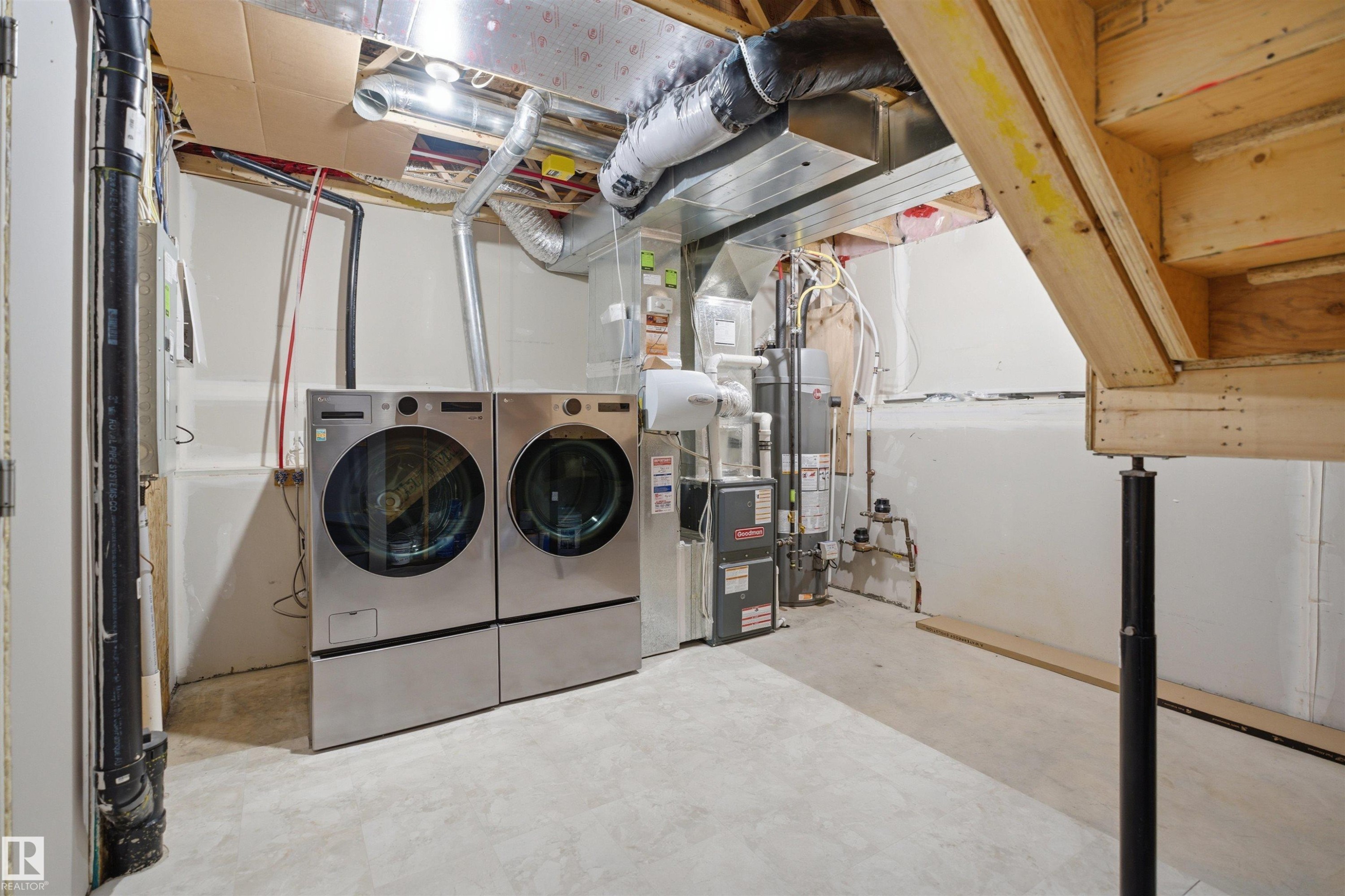 Utility area with concrete flooring and exposed ceiling joists - 33 7385 Edgemont Way Nw, Edmonton, AB - Indoor Photo Showing Laundry Room