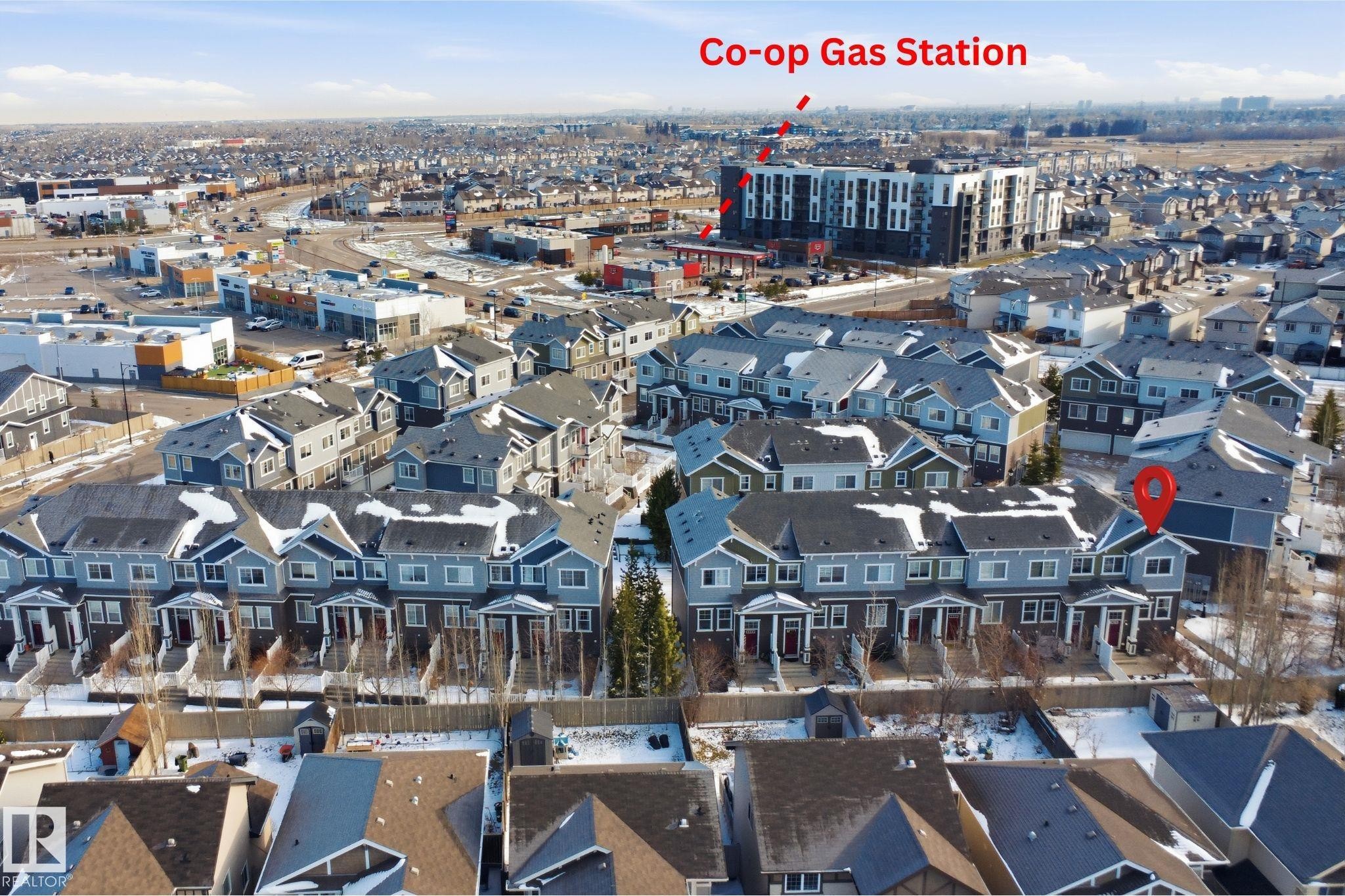 Townhome community featuring multi-story residences with gabled roofs and individual front entrances - 33 7385 Edgemont Way Nw, Edmonton, AB - Outdoor With View