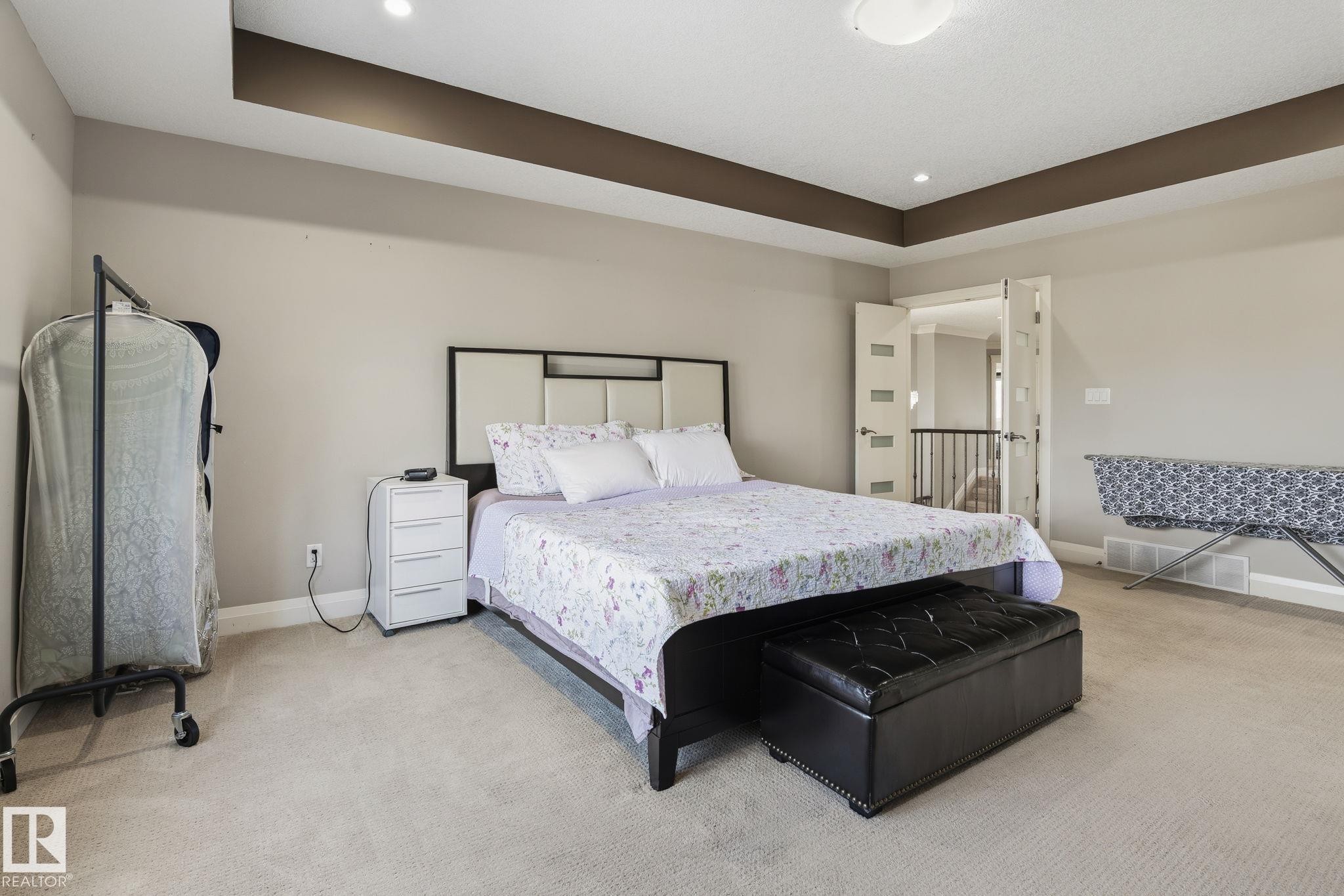 Tray ceiling with recessed lighting and a central flush-mount fixture - 731 57 Street Sw, Edmonton, AB - Indoor Photo Showing Bedroom