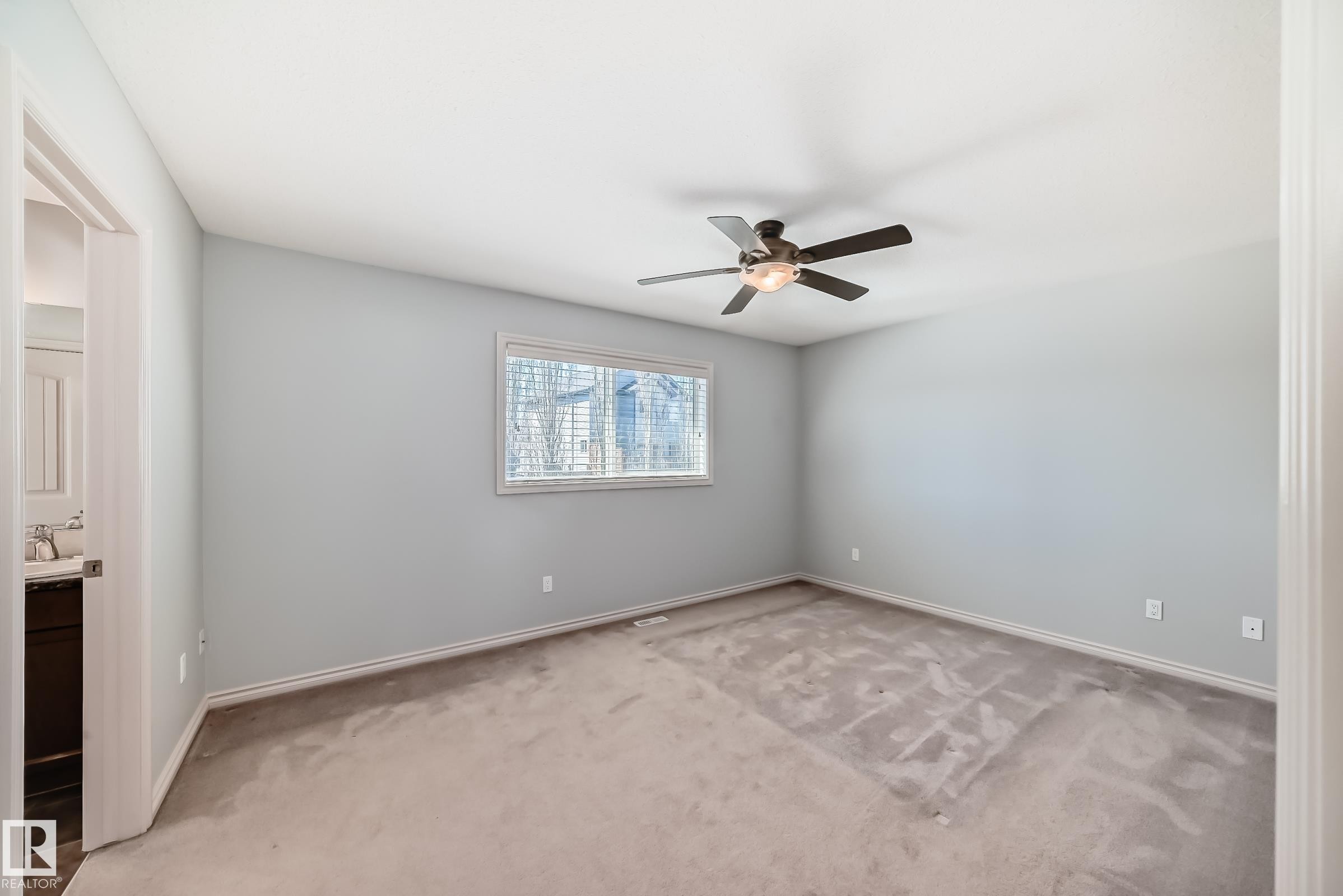 Bedroom featuring neutral gray wall paint, a ceiling fan with integrated lighting, a window with blinds, and light-colored carpeting - 6723 19 Avenue, Edmonton, AB - Indoor Photo Showing Other Room