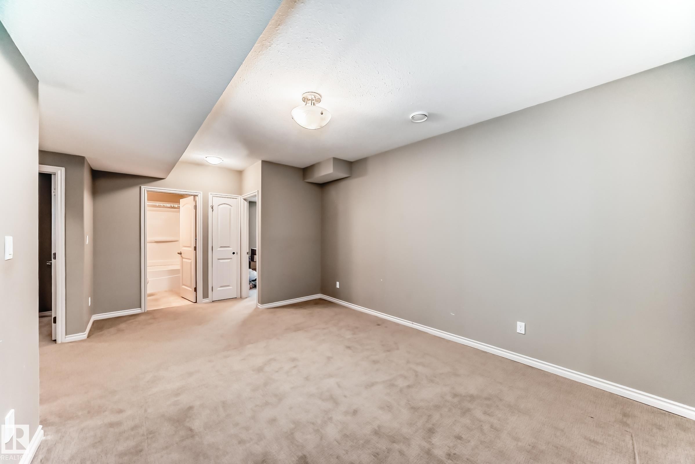 Carpeted room with neutral-toned walls, white trim, and a semi-flush mount ceiling fixture - 6723 19 Avenue, Edmonton, AB - Indoor Photo Showing Other Room